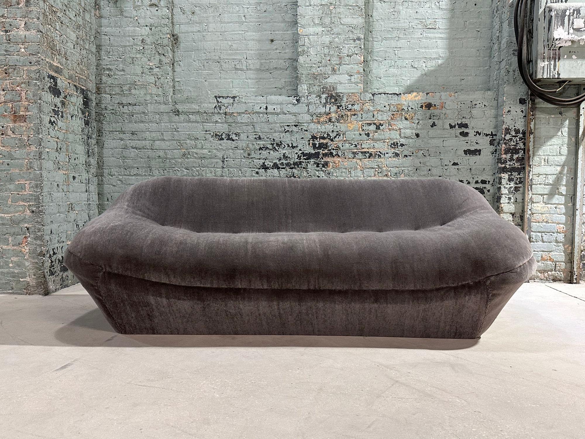 Post Modern Sculptural Pouf Sofa, 1980.  Newly upholstered in ultra plush mohair
A post-modern sculptural pouf sofa is a unique and artistic piece of furniture that combines elements of both sculpture and seating. It embodies the aesthetic