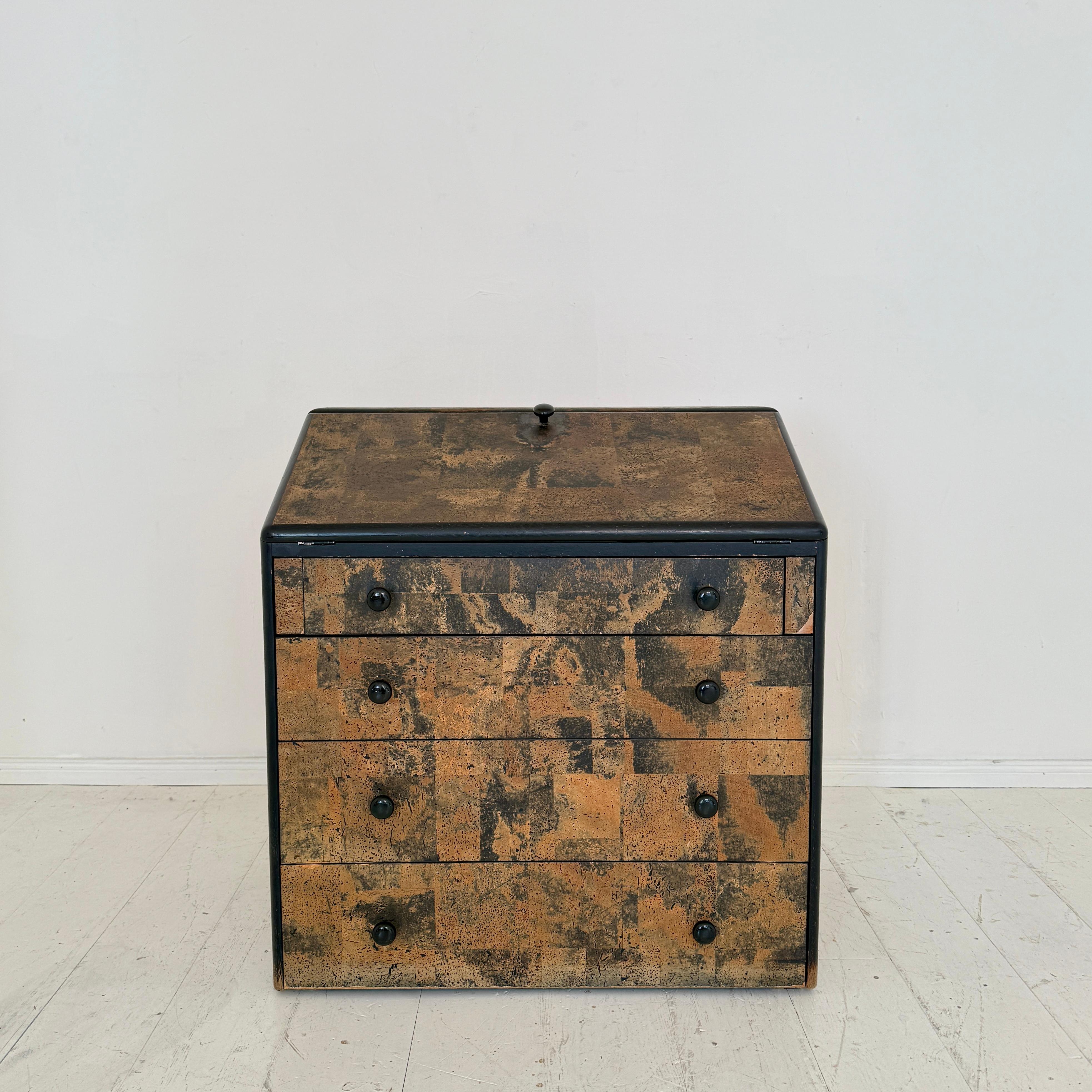 A rare Post-Modern secretaire designed by Peter Maly as part of the Serie 5 collection, dating to around 1975. This distinctive piece is crafted with a striking cork veneer, contrasted by sleek black framing, embodying the innovative materiality and