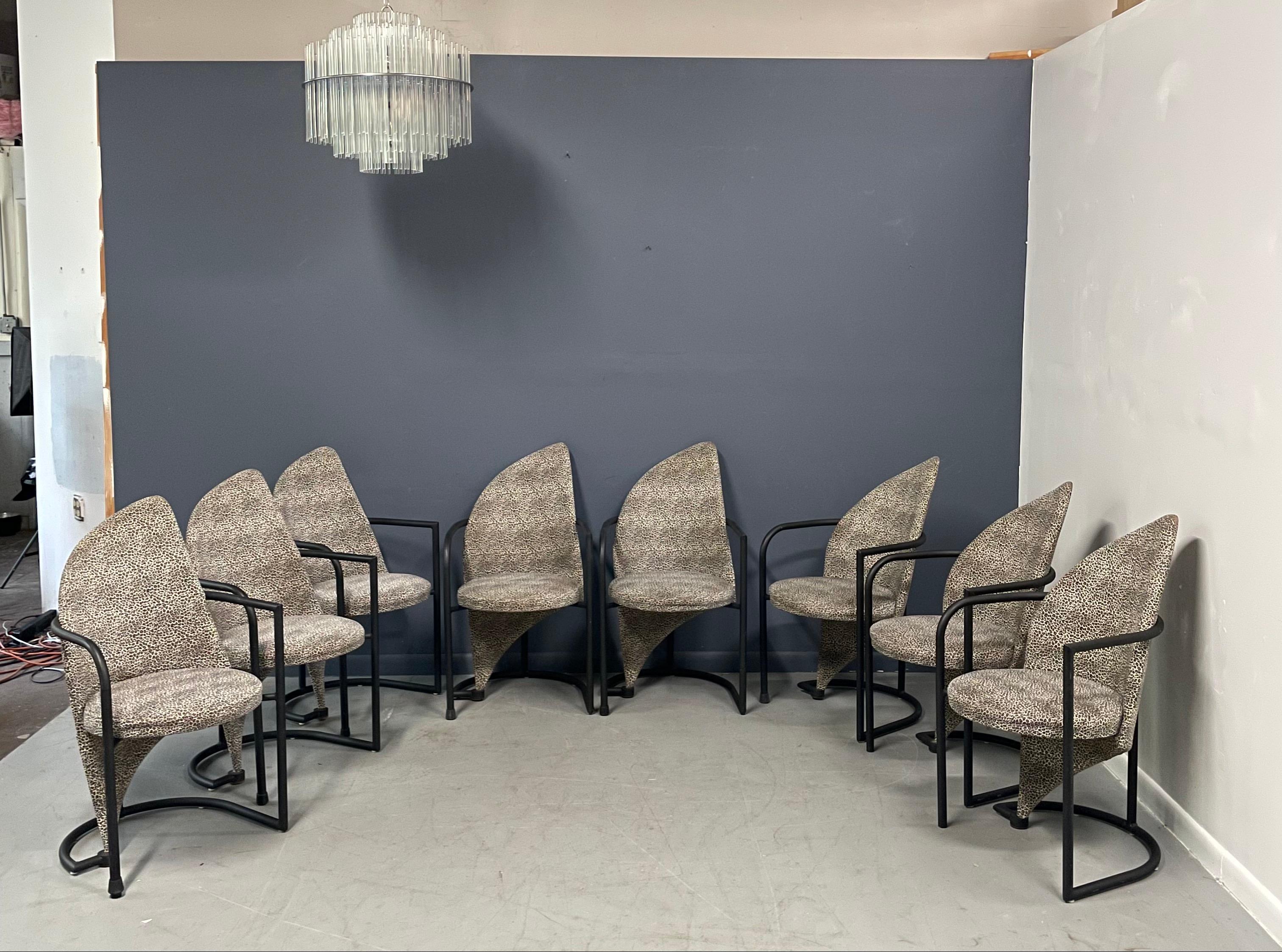 Great post modern design dining chairs by Cal Style with an asymmetrical design upholstered in a cheetah print fabric that can be redone in a fabric of your choice.