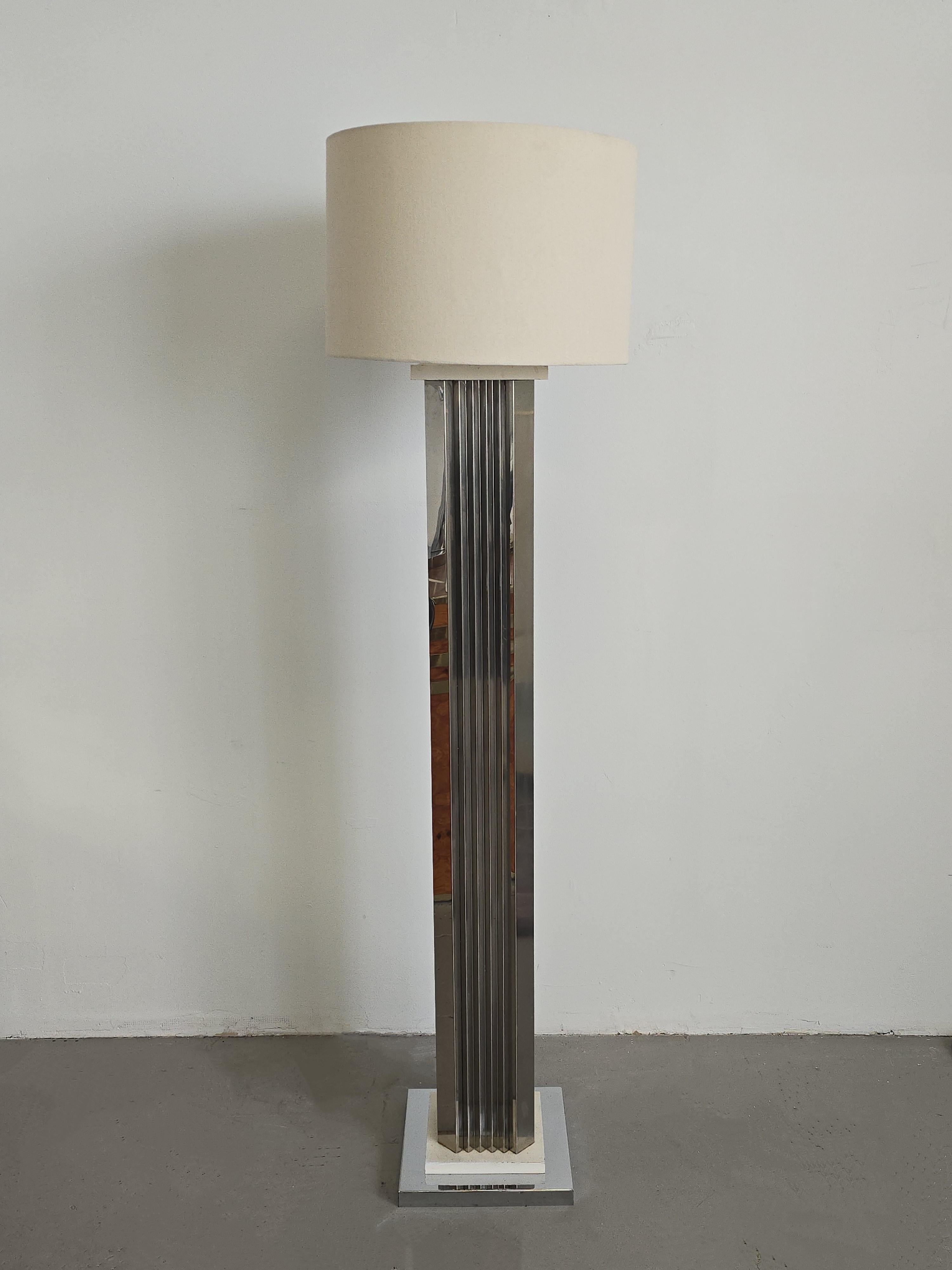 Post Modern Style 'skyscraper' chrome floor lamp attributed to Casella Lighting. This lamp was believed to be made in the 1970s. The body of the lamp has chrome panels resembling the folds of an accordion. It looks mirrored and is reflective. The