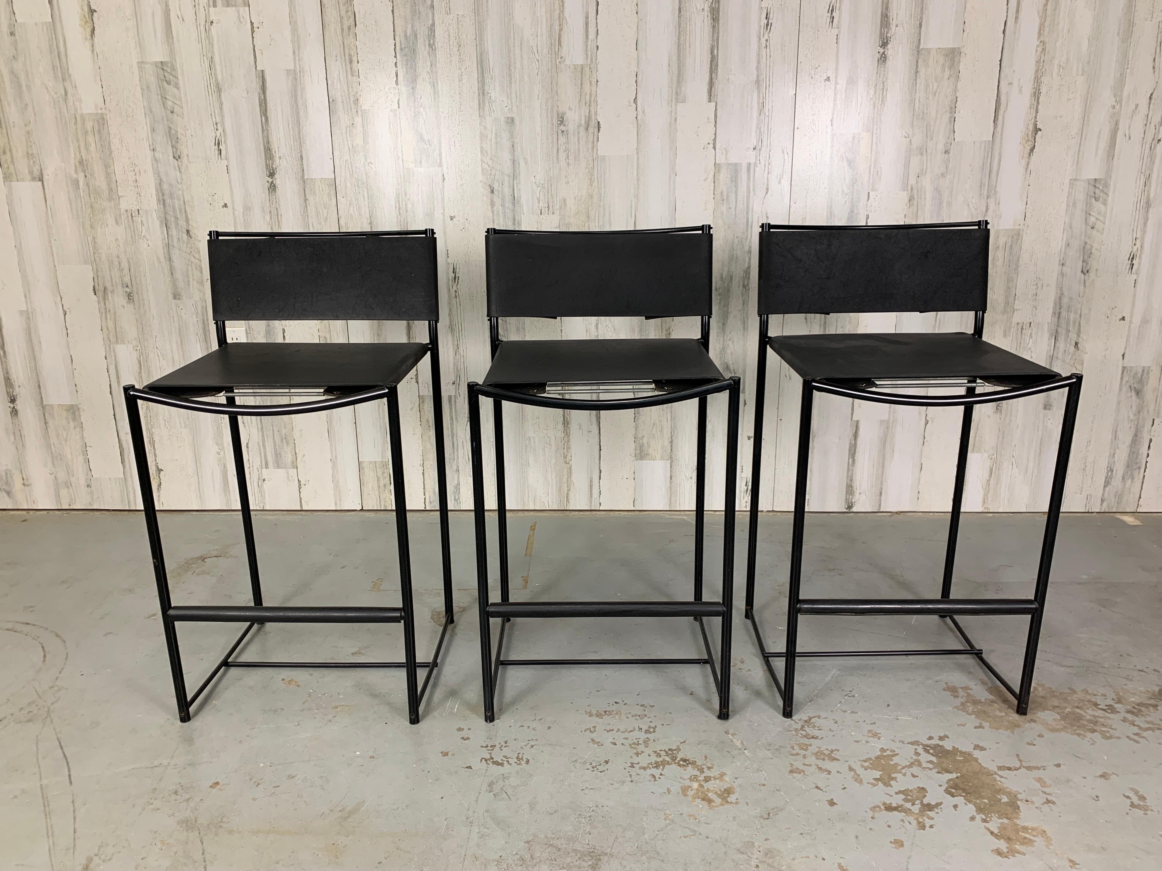 Set of three powder coated metal frames with rubber sling seats and back.