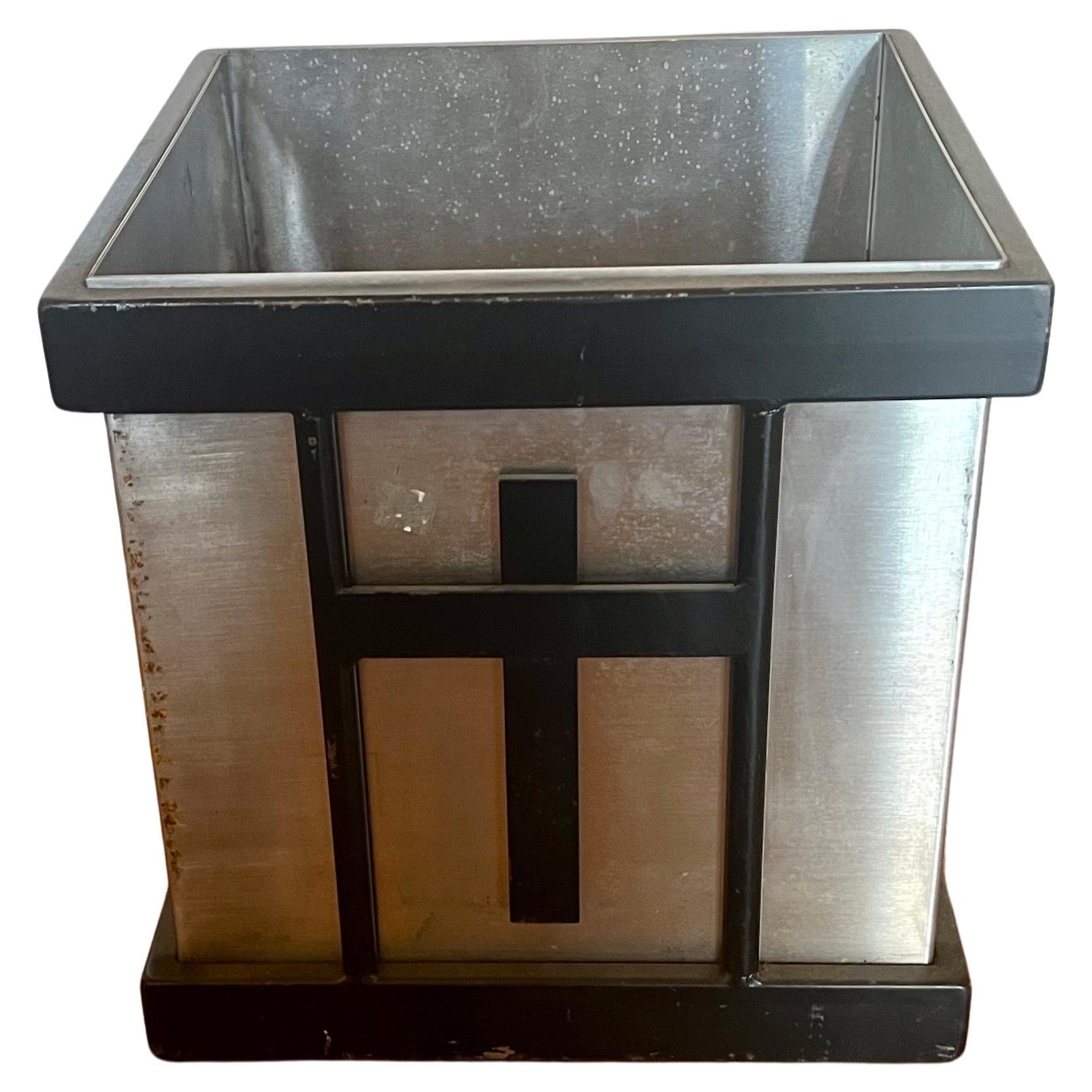 Rare solid stainless steel custom-made planter, waste basket with black enameled steel metal accents circa 1980's.