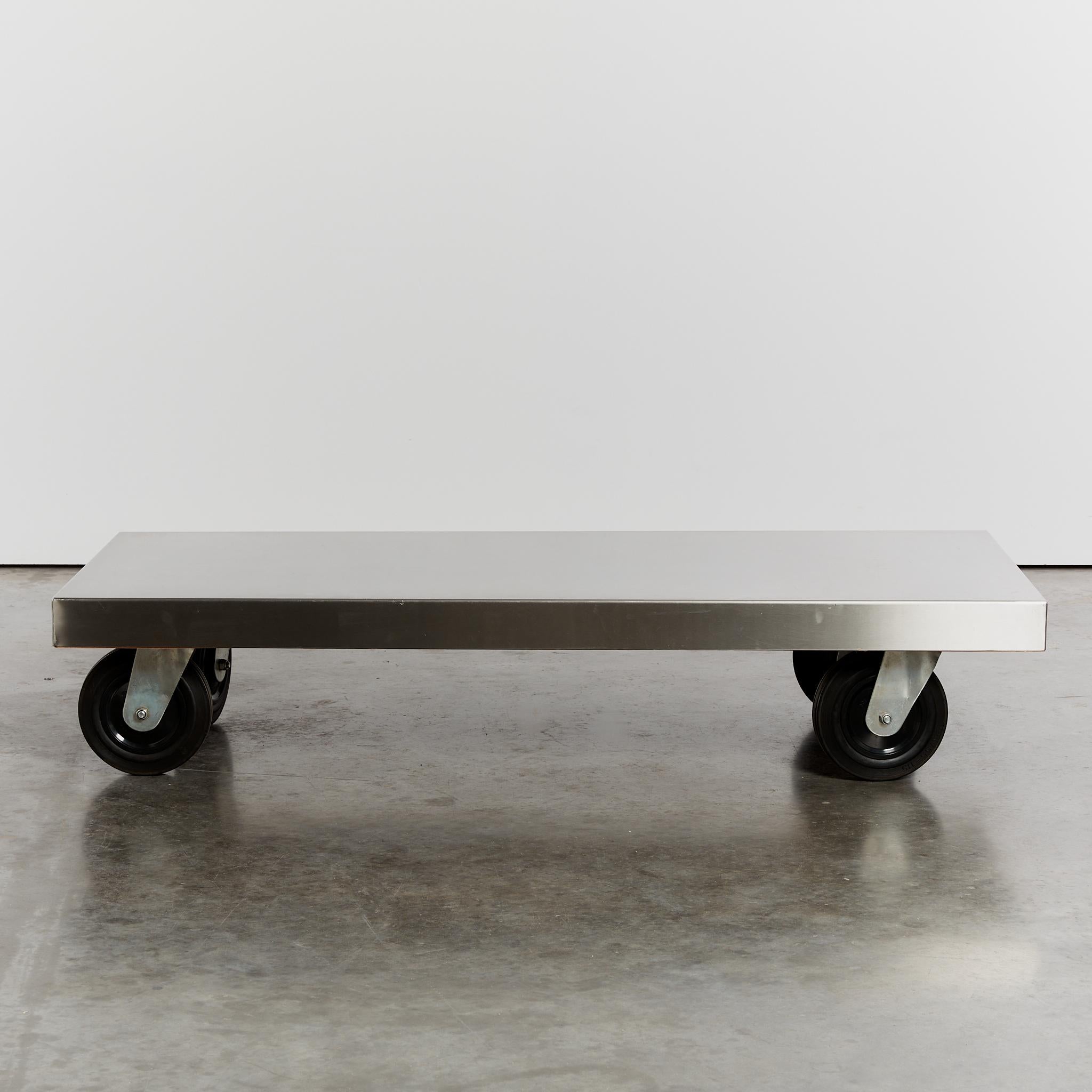 Oversized flat stainless steel coffee table on large black castors.

Material: Stainless steel

Period: Circa 1990's

Origin: Netherlands

Dimensions:  L160 x W75 x H32cm

Condition: Vintage condition - a few subtle signs of wear on the surface,