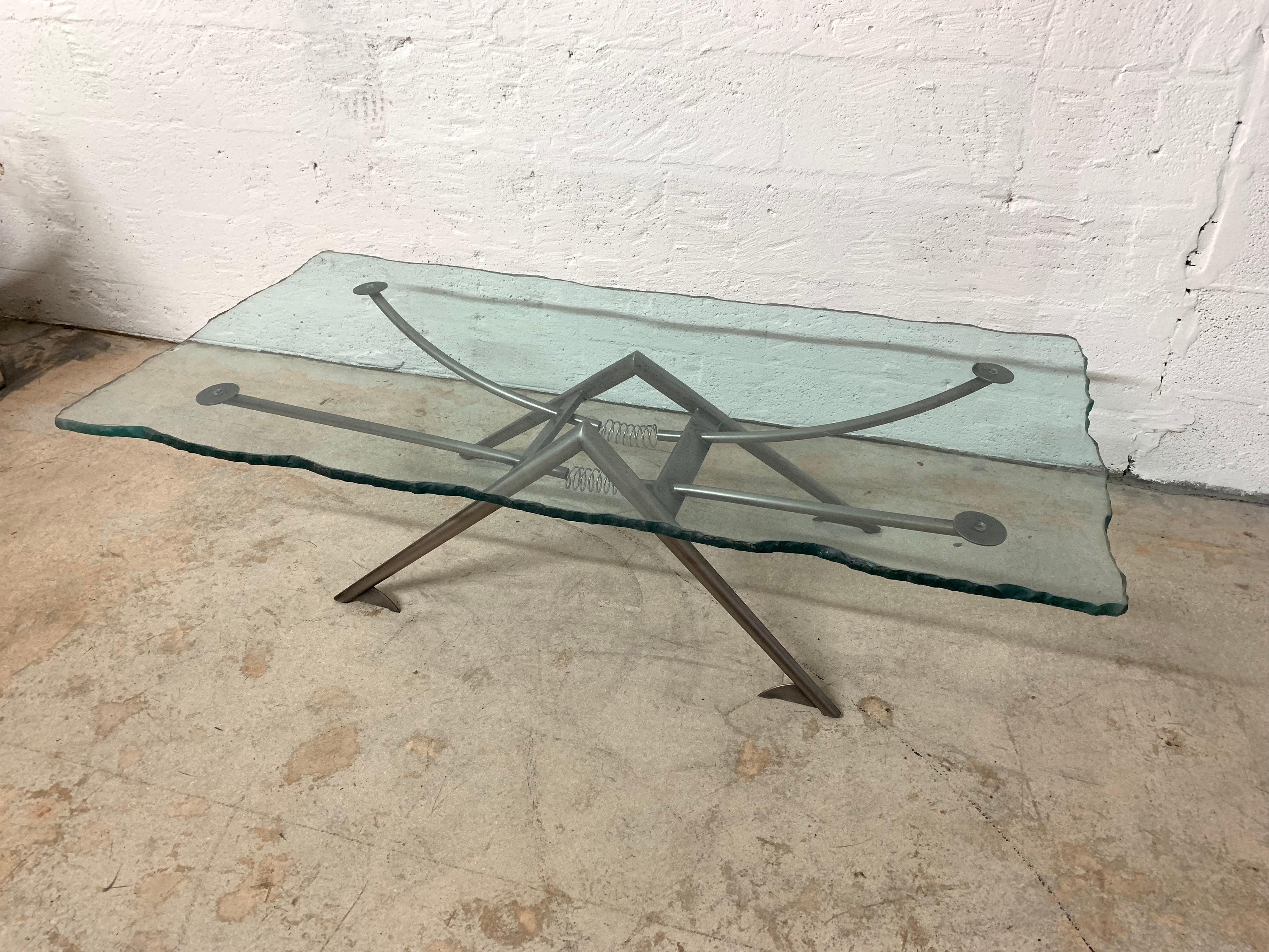 Post Modern coffee or cocktail table inspired by San Francisco Earthquake, comprised of steel armature base and a sandblasted chiseled edge glass top, designed by Rick Lee for DIA, Design Institute of America, USA, circa 1989.