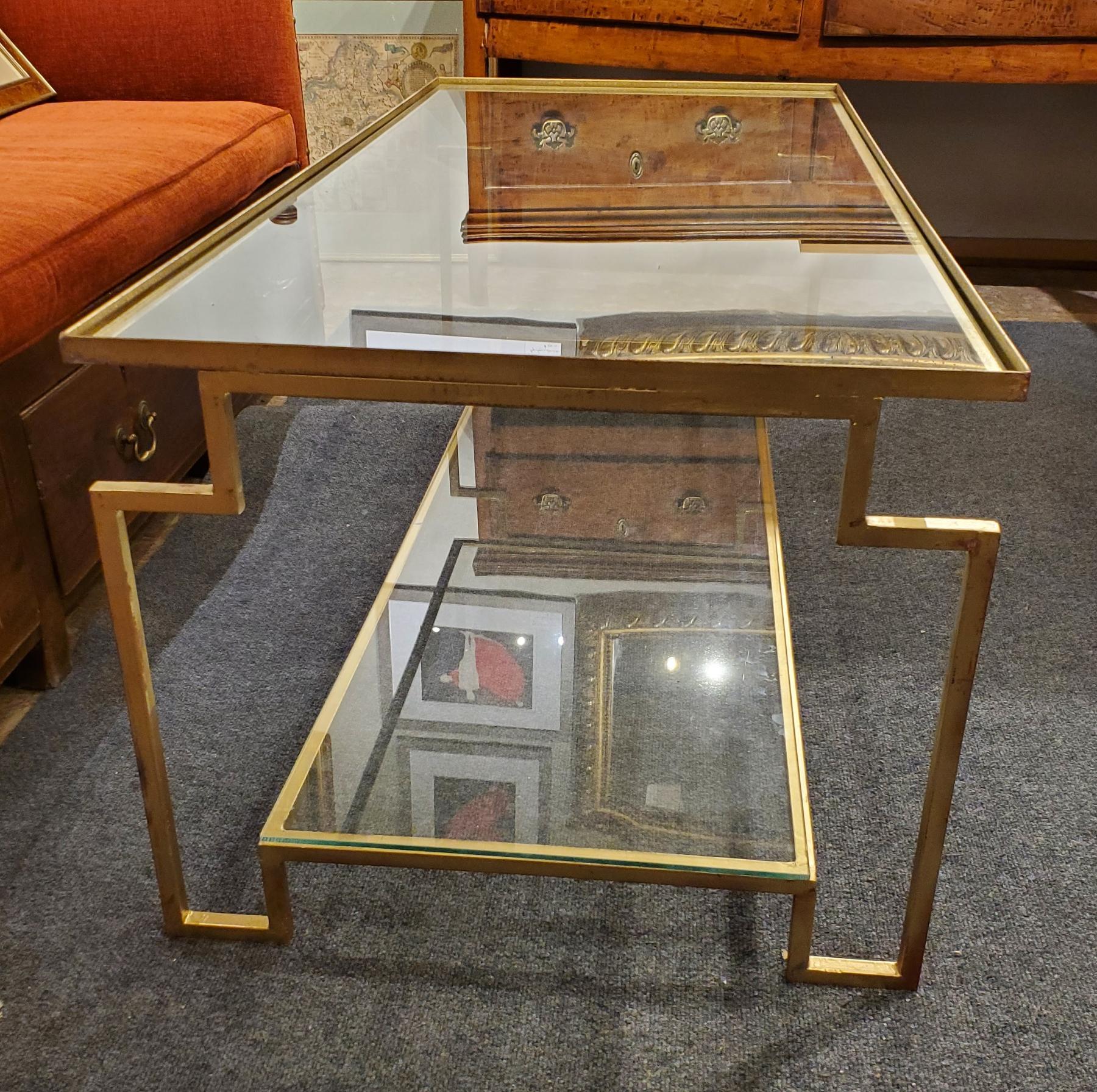 Post Modern Style “Apollo” gilt metal coffee table. Excellent proportions, very architectural with a “distressed” gilt finish to the metal and a glass top above a glass shelf. Designed by Hastening Designs - made in Virginia and the size can be