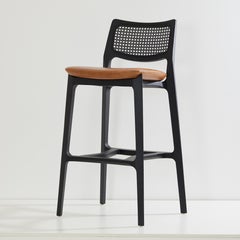 Hocker im postmodernen Stil, schwarzes Massivholz, Rückenlehne aus Rohr, Sitzfläche aus camelfarbenem Leder