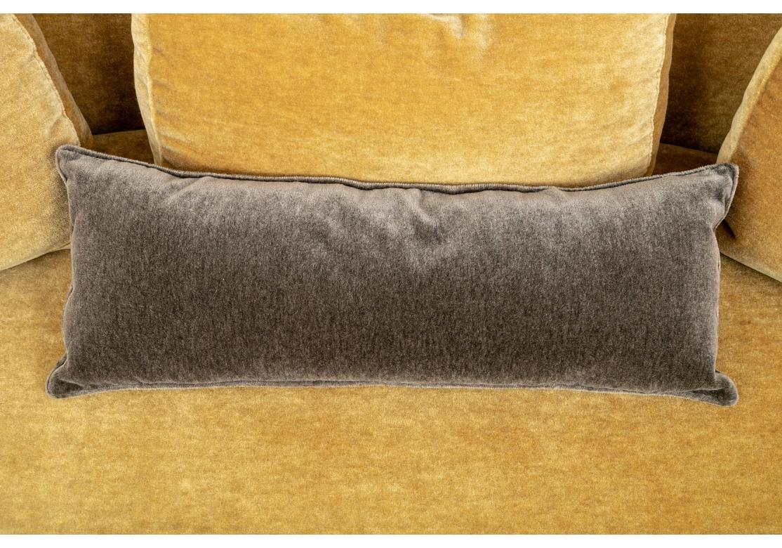 A Post Modern style Mustard Mohair Sofa with three matching accent pillows. The Serpentine form with fixed back and unusual back legs flowing from the top to the bottom in nearly the full length of the sofa. The wedge form arms are suspended above