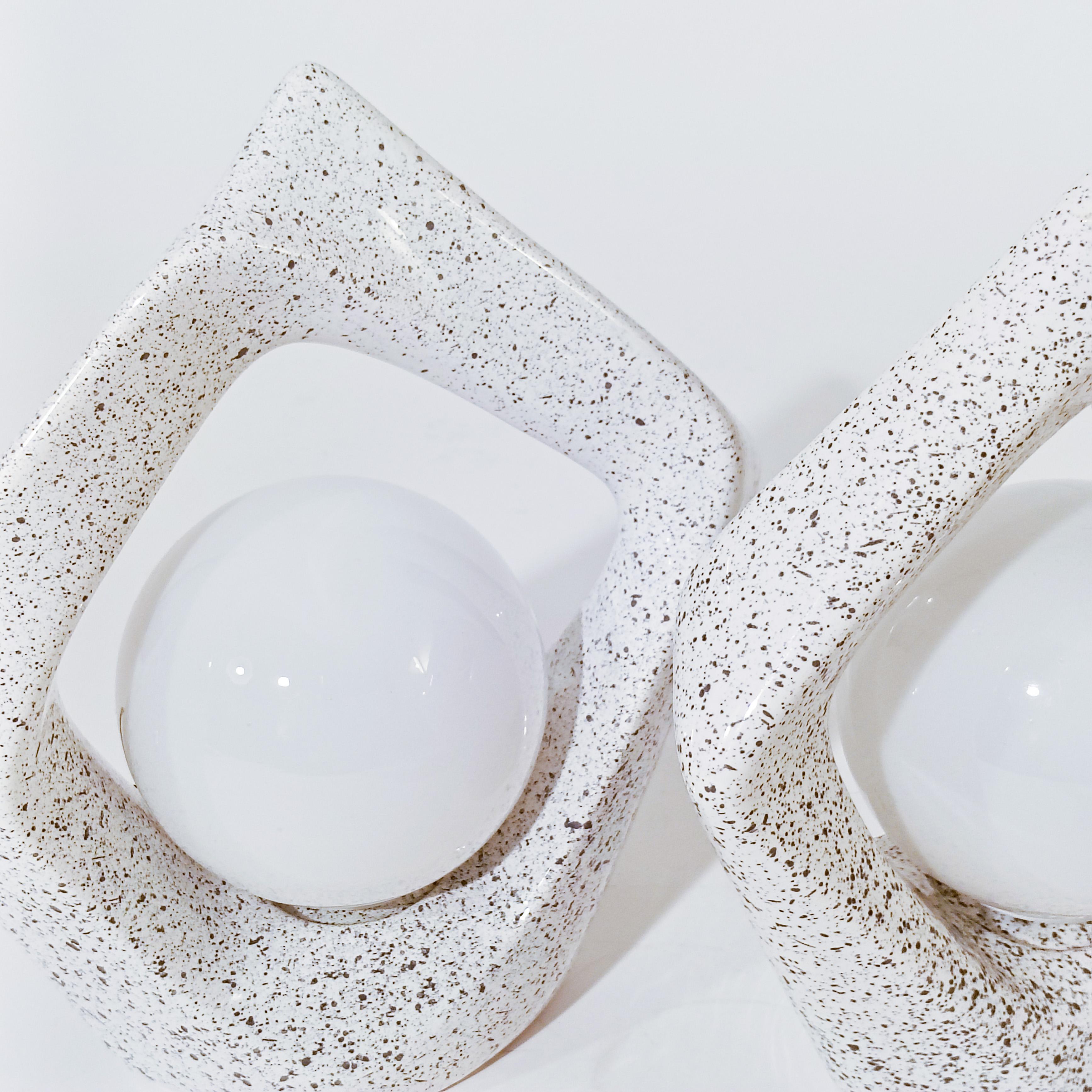 Sculptural ceramic table lamps, Spain, 1980s. Made of ceramic with an abstract shape similar to a rock, with a light gray glazed finish and hand-painted with splashes of black paint. Opaline diffuser. Space Age and Brutalist style.
Very much in the