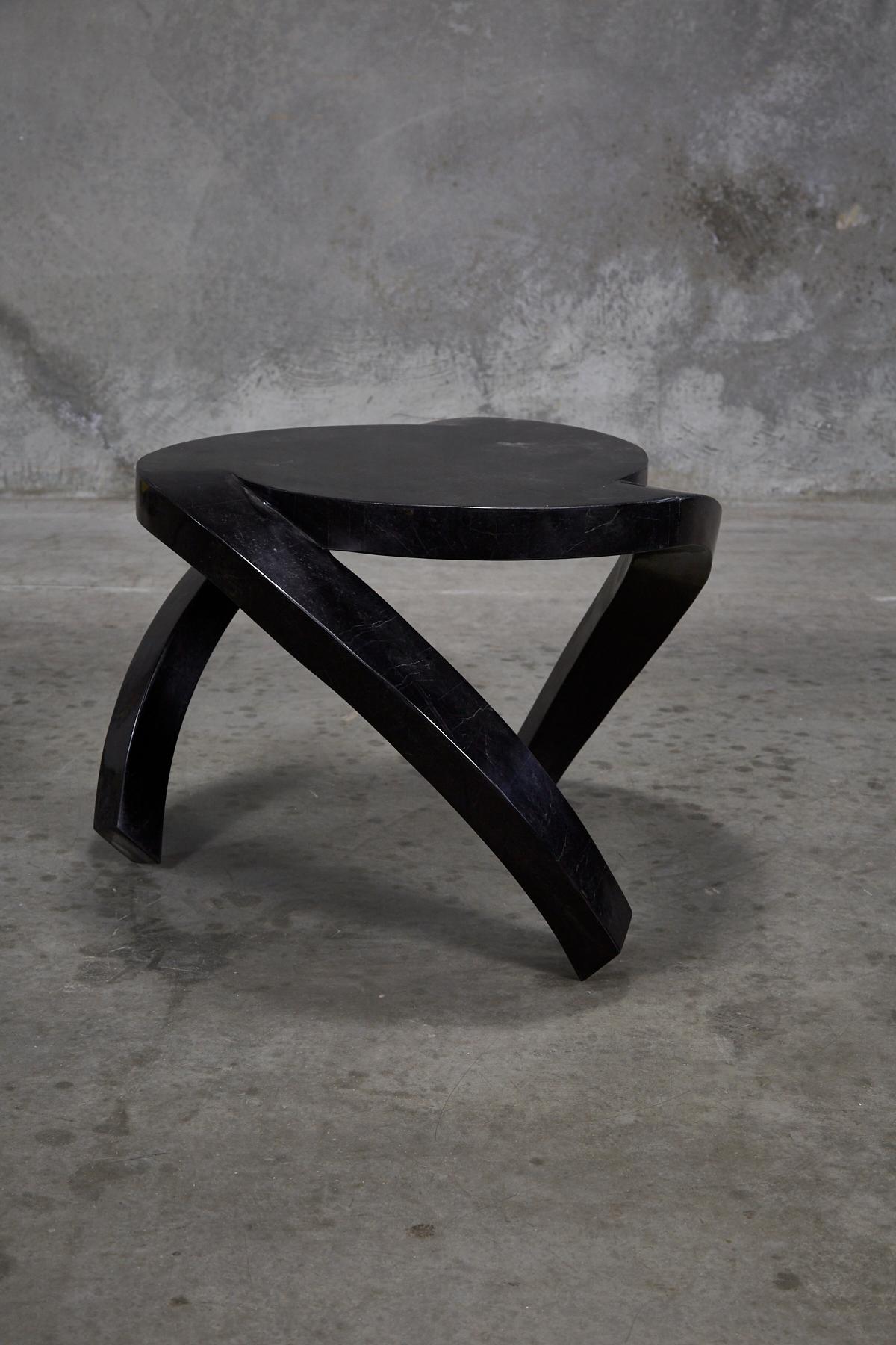 Dynamic side table completely hand-inlaid with black Cantor stone over fiberglass and wooden body. All natural stone with no lacquer or additional finish.

Coordinating cocktail table also available, item no. LU1484213918652.

All furnishings are