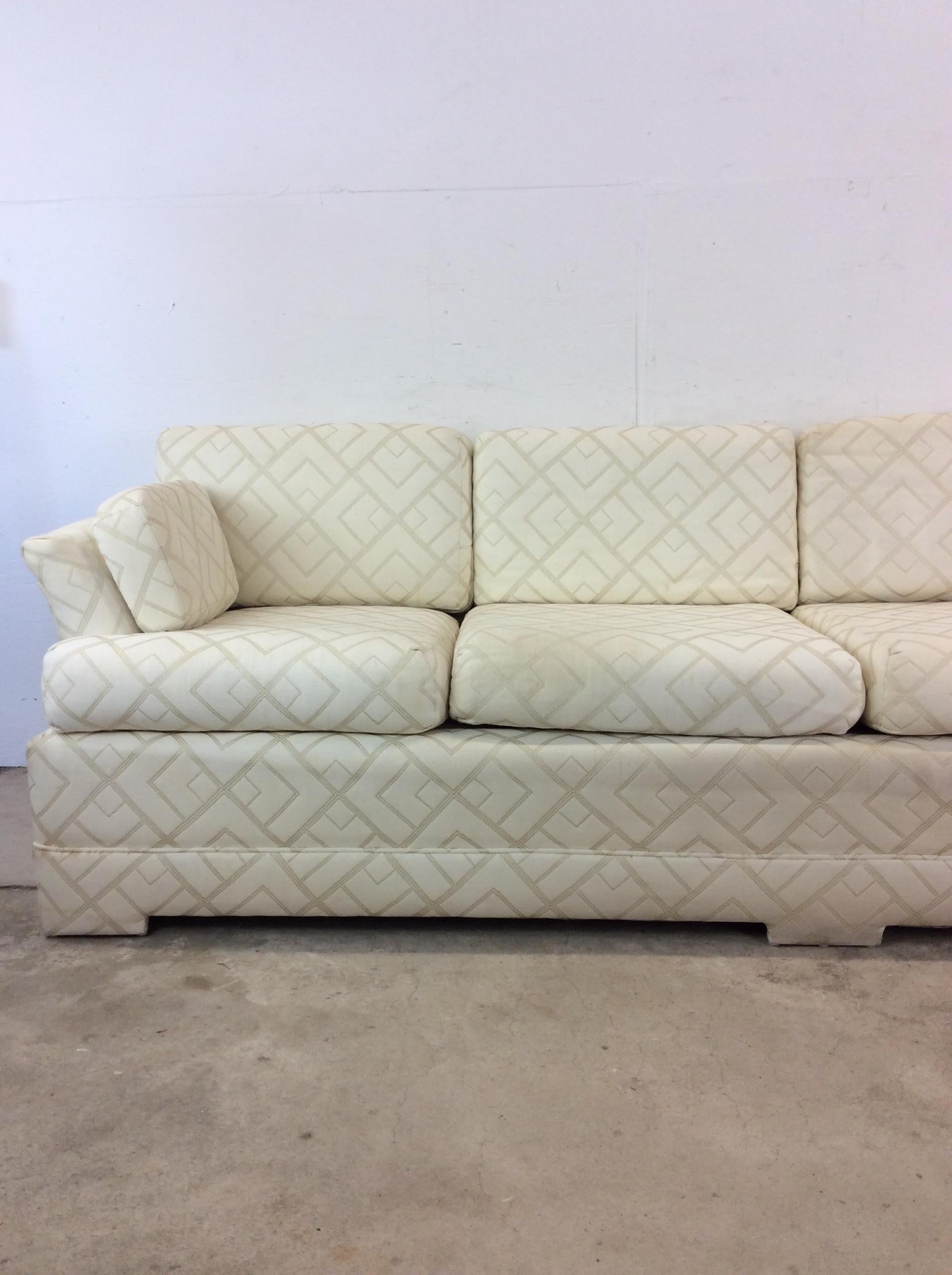 This postmodern three seater sofa features vintage white patterned upholstery with removable cushions and unique oversized armrest.

Dimensions: 84.5w 35.25d 30h 26ah 17sh

Condition notes: Vintage upholstery is in good condition. Lot of life in the