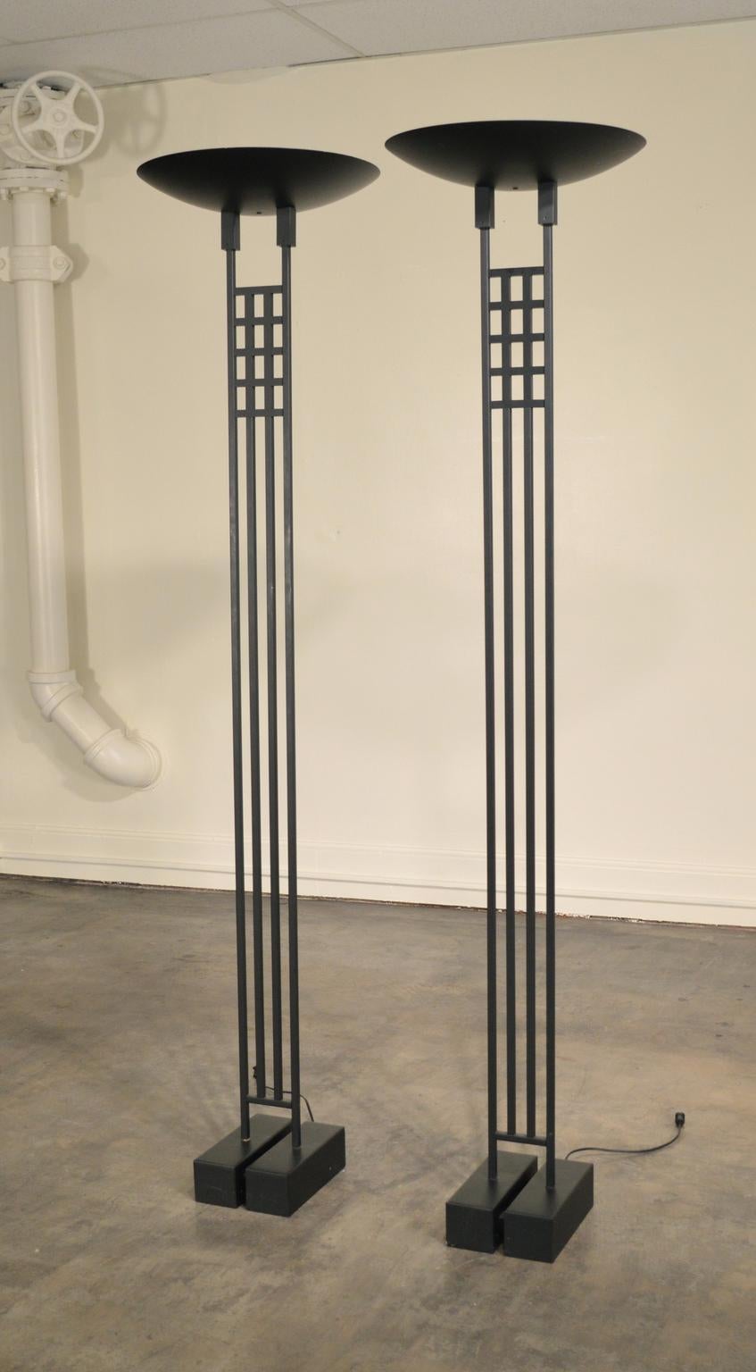 A  tall pair of black metal halogen Post-Modern torchieres designed by Robert Sonneman, in the 1980's,  in the style of Scottish Architect and Designer, Charles Rennie Mackintosh. This design, with its roots in an Arts and Crafts aesthetic, would go