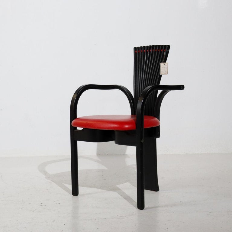 This rare chair was designed in Norway in 1984 by Torstein Nilsen for Westnofa. The chair is of very luxurious and high quality and made of natural oak, lacquered in black. The loose legs of the 'fan shape' in the backrest are 'connected' to each