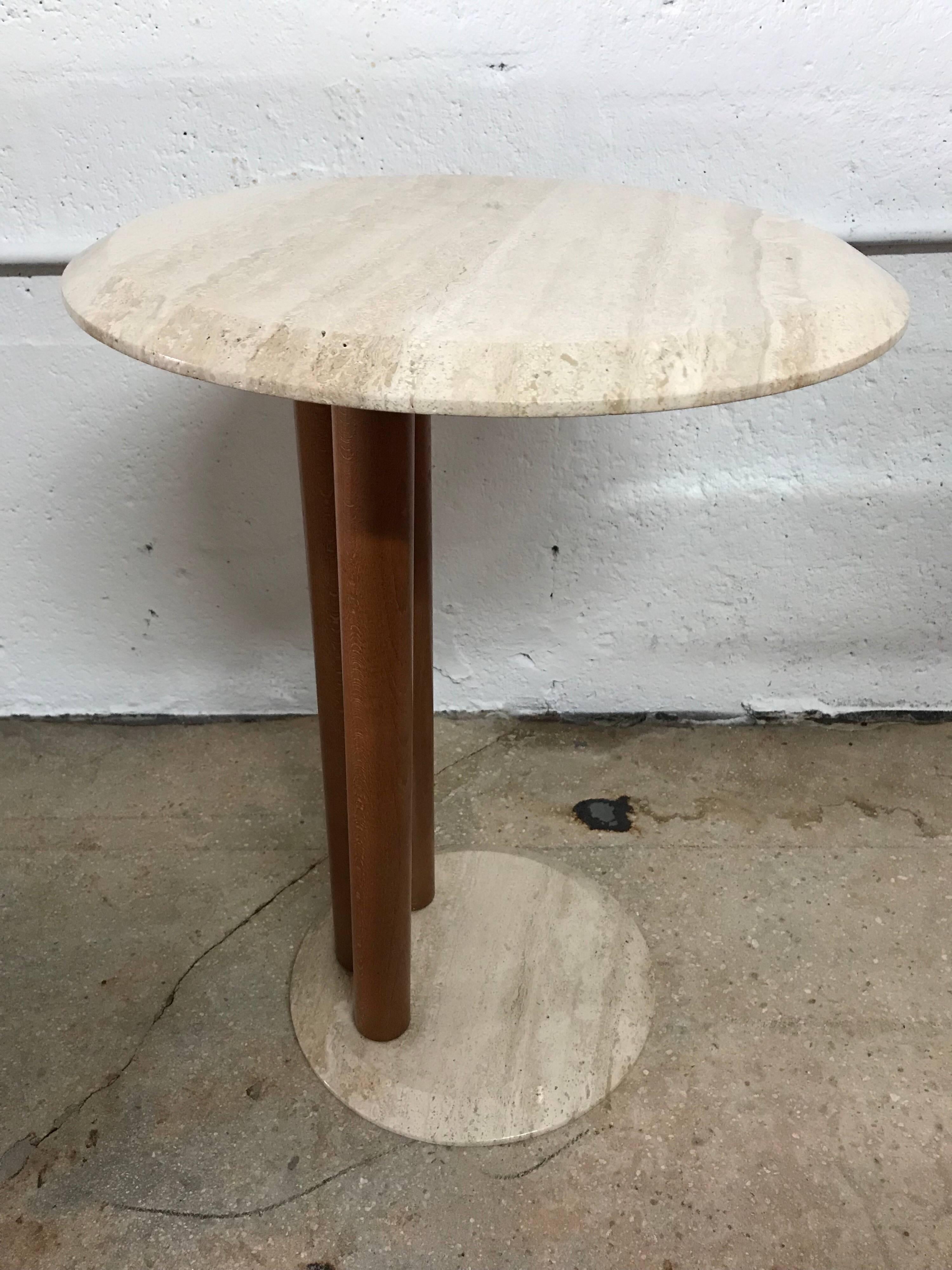 Round postmodern side or end table with an offset base and top rendered in edge beveled travertine supported by three wood cylinders, Memphis design style, Italy, 1980s