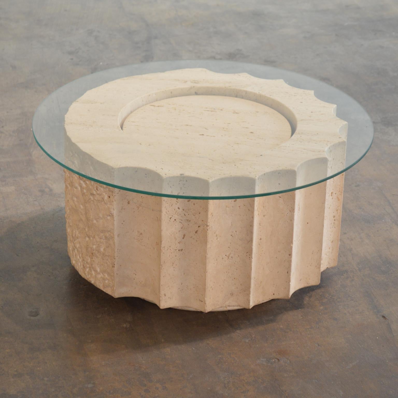 Post-Modern Travertine coffee table or low side table in the form of an unfinished section of Doric column; two thirds of the column are fluted, with the remainder rough-hewn. Purchased in the 1980s from a dealer of Italian design and attributed to