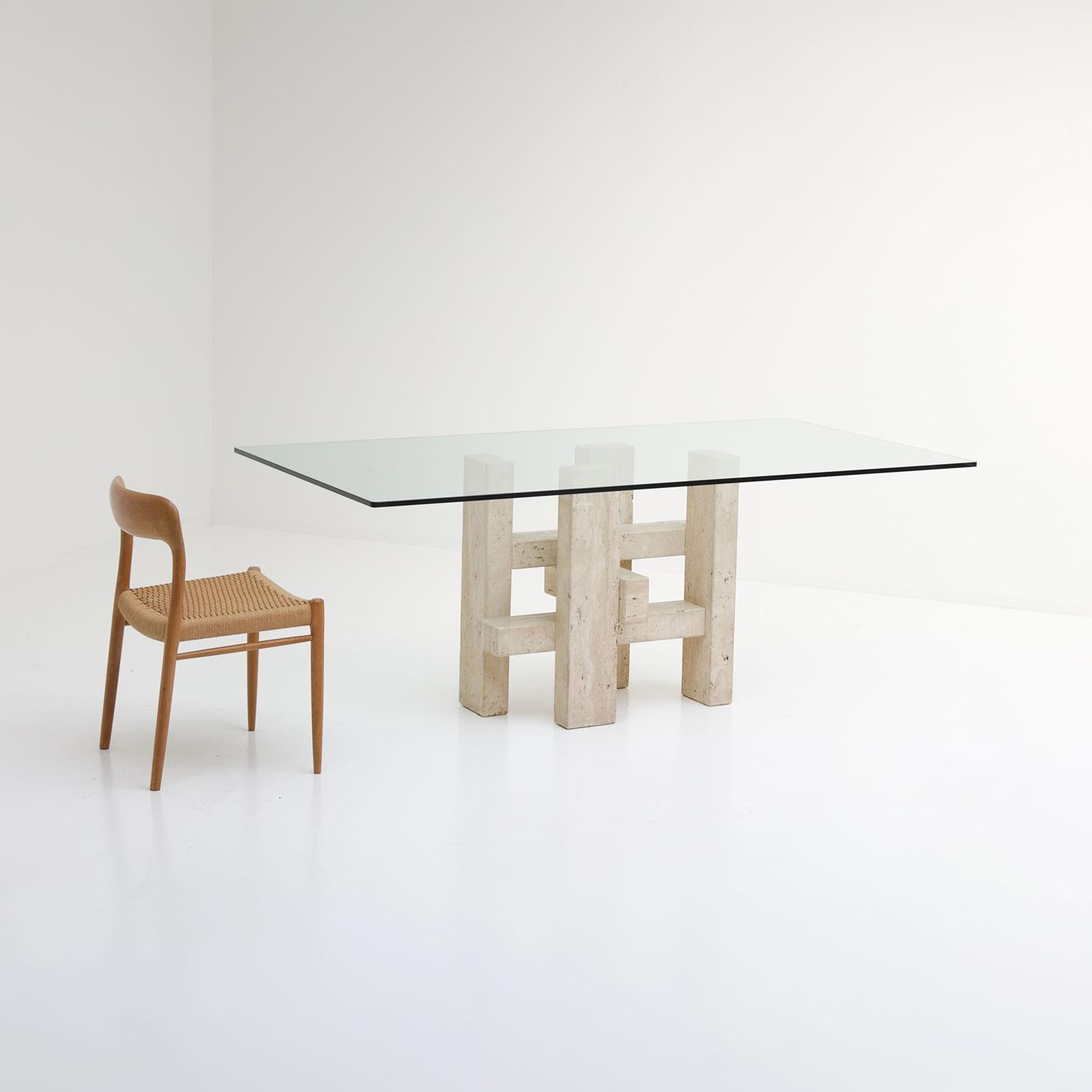 Travertine sculptural dining table, Scarpa, Mangiarotti

The table has a solid travertine base with an architectural feel and glass tabletop. The table has a modernist influence and stands in a good, original condition, the glass has no chips or