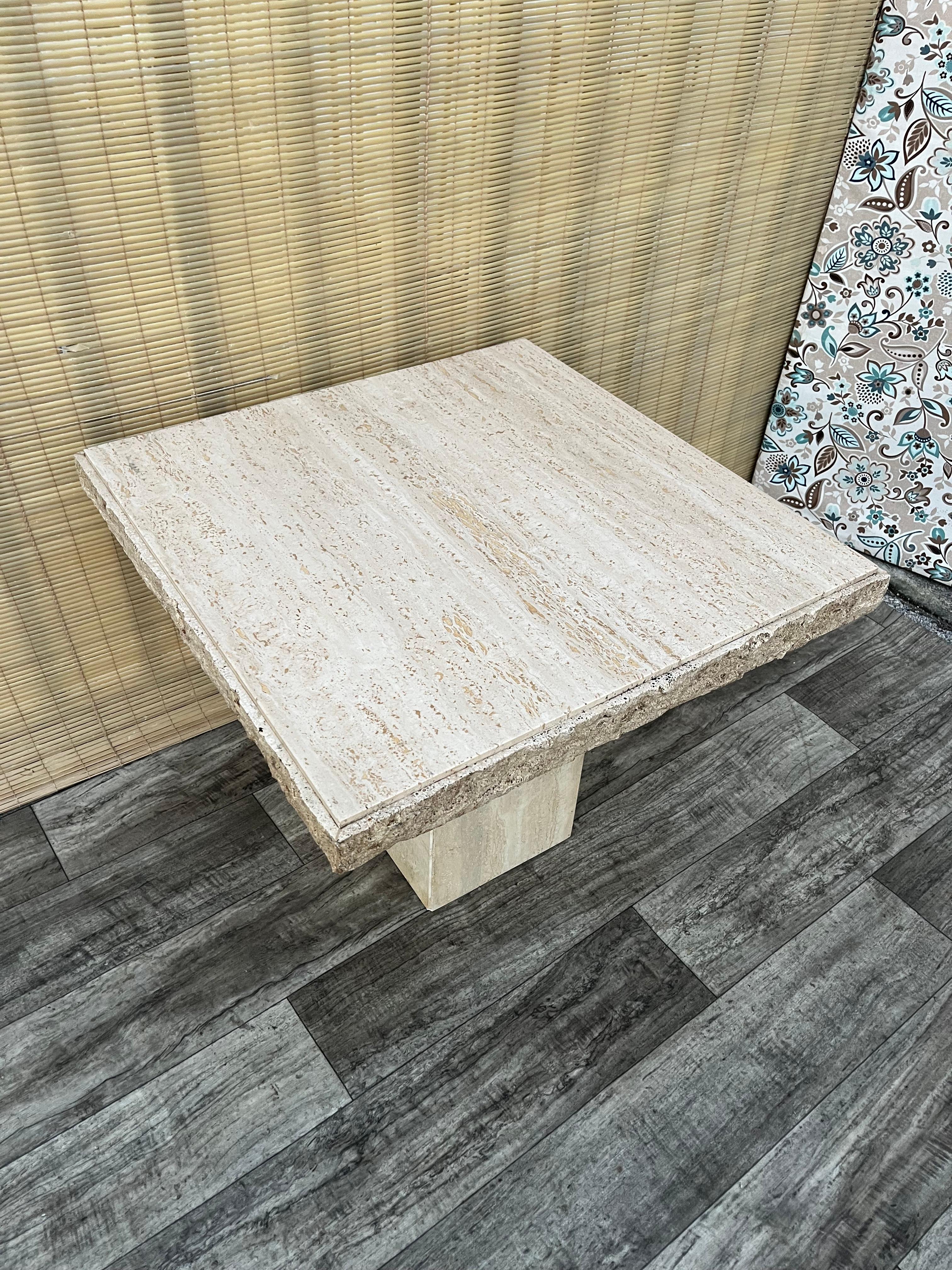 Vintage Post Modern Travertine Side Table by Stone International. Circa 1980s
Features a minimalist design with a light tan polished travertine stone, beautiful natural stone veins and grain, a polished square pedestal, and a removable top for easy