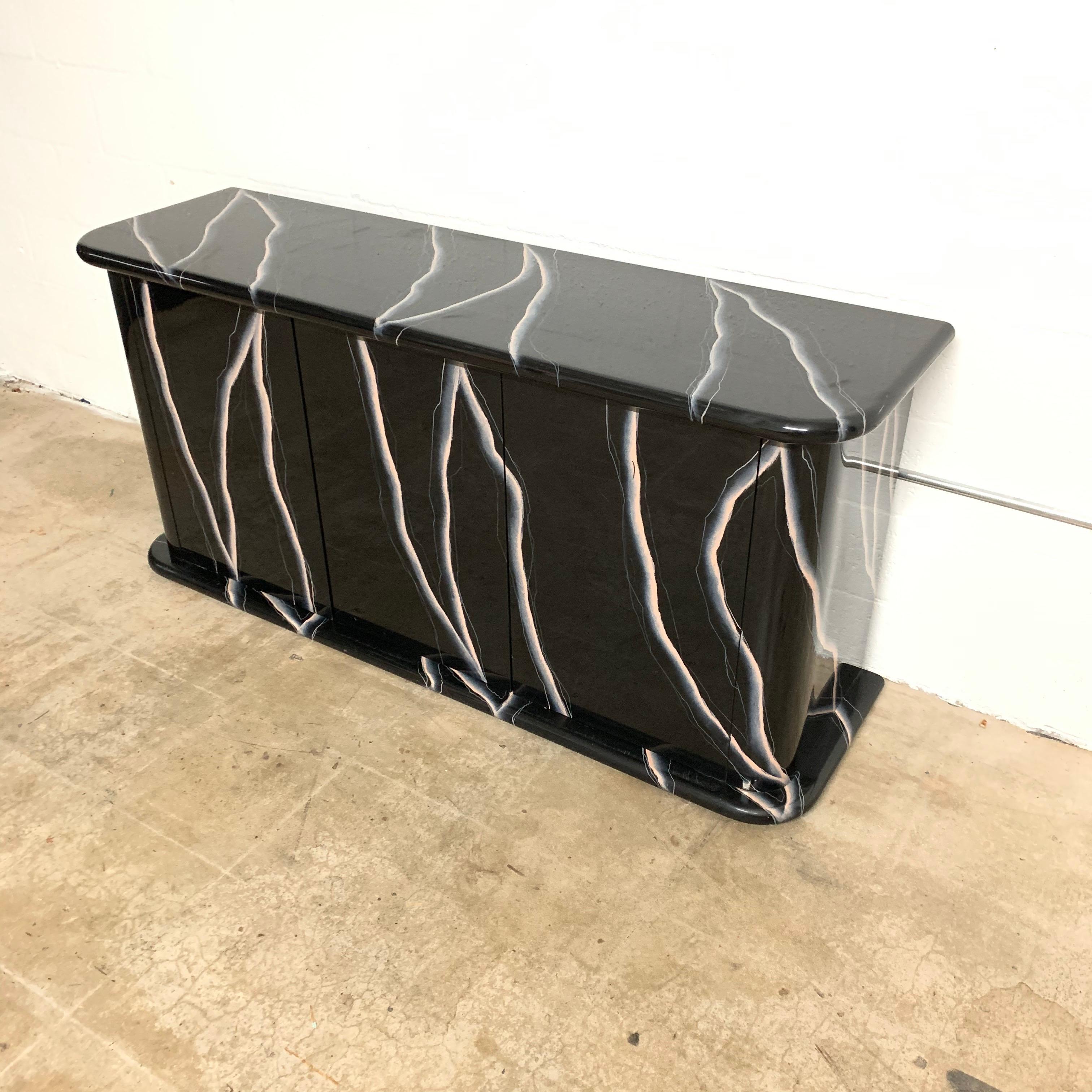 Unique buffet or sideboard credenza rendered in hand printed lighting marble with 3 doors and interior shelves.