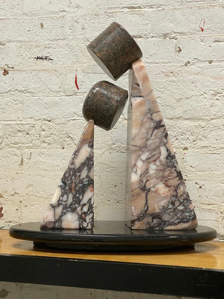 Carved pink and black marble Postmodern sculpture by Renaissance Man, Anthony Gennarelli. Sculptor, painter, musician and teacher; Gennarelli composed and sculpted in his home in Orange County, New York. He produced a fine body of work that is now