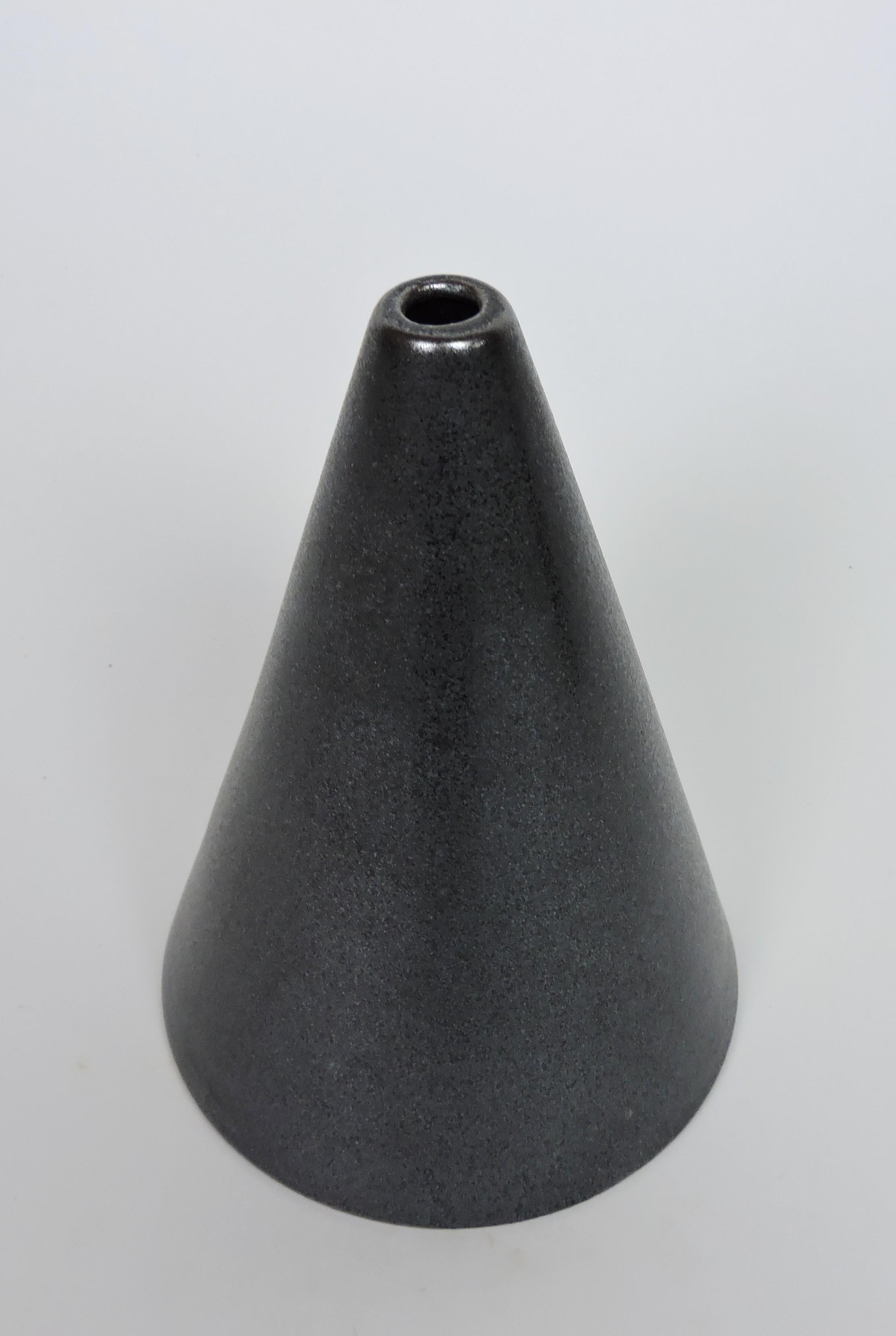 Beautiful post-modern minimalist style conical vase designed by Mexican designer, Victor Carranza, and manufactured in Japan by Mikasa. This vase has an Asian influenced form and a striking gunmetal glaze. Signed Victor Carranza on the bottom and
