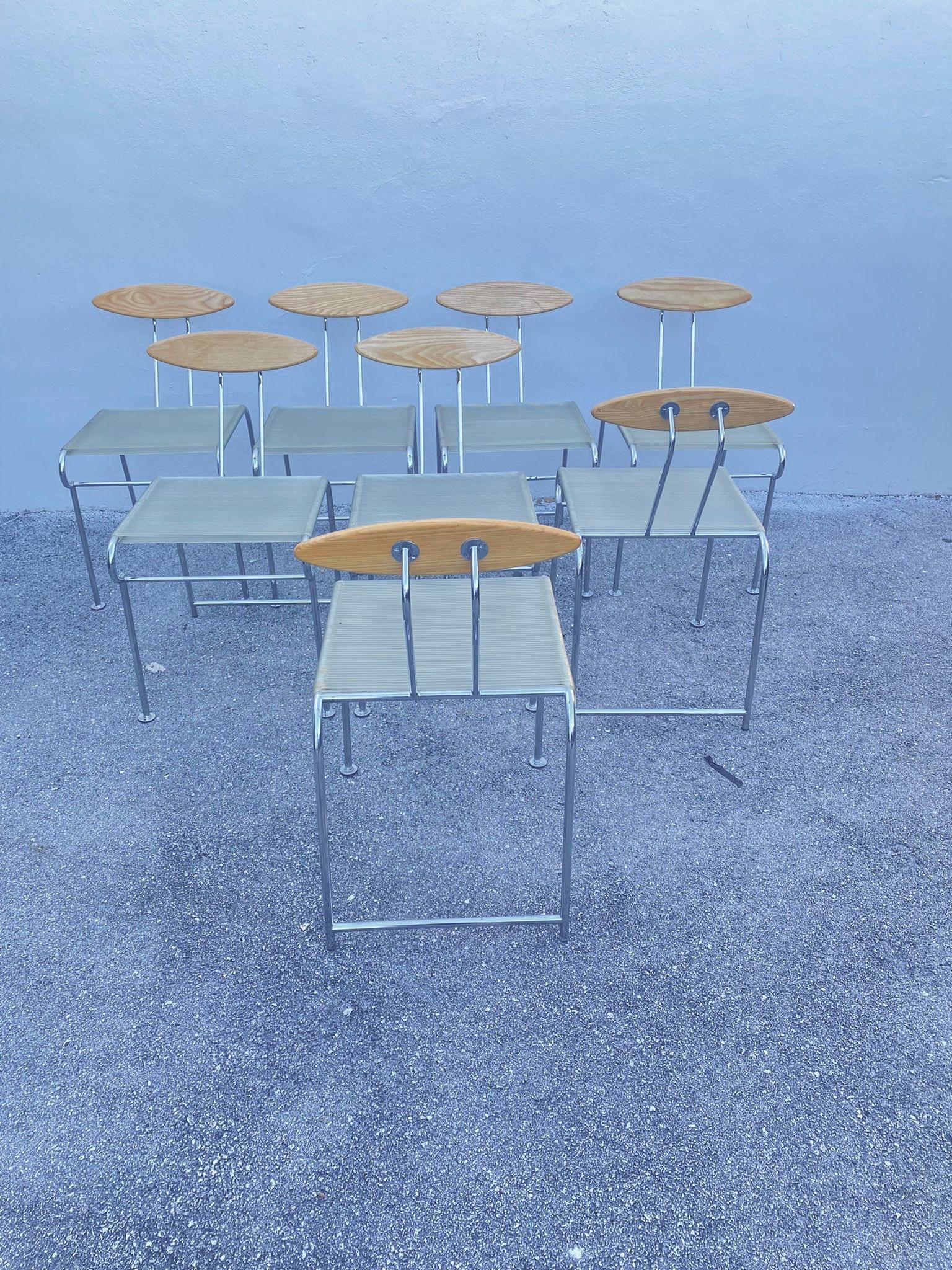 Postmodern Memphis style vintage dining chair set designed by Massimo Iosa Ghini for Moroso circa 1987 Italy. Made of metal, ashwood and clear elastic rubber strands. A RARE group of 8 dining chairs with solid ashwood backrests in elliptical shape