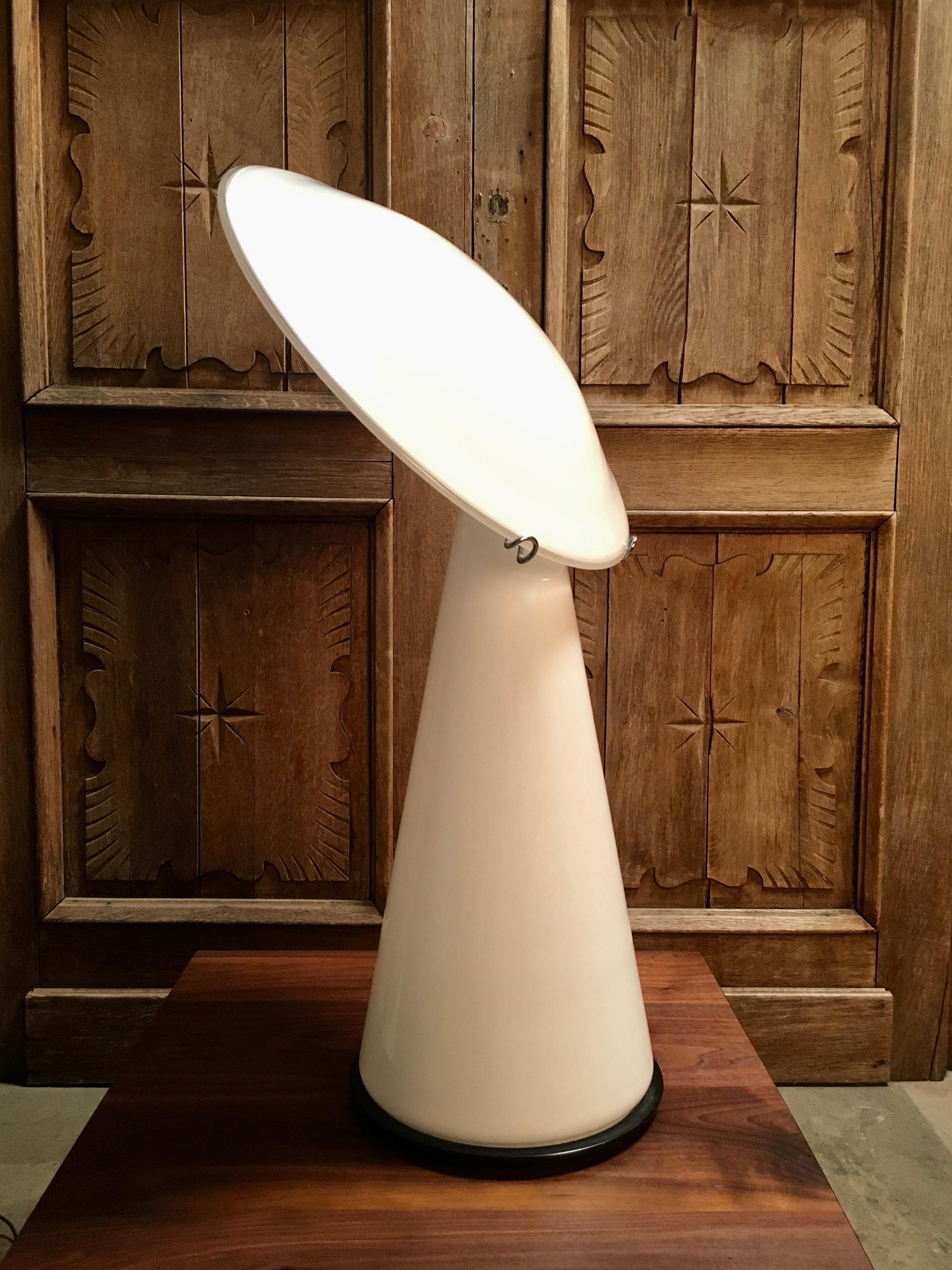 Postmodern Vistosi table lamp with slanted glass disc on a conical glass base.