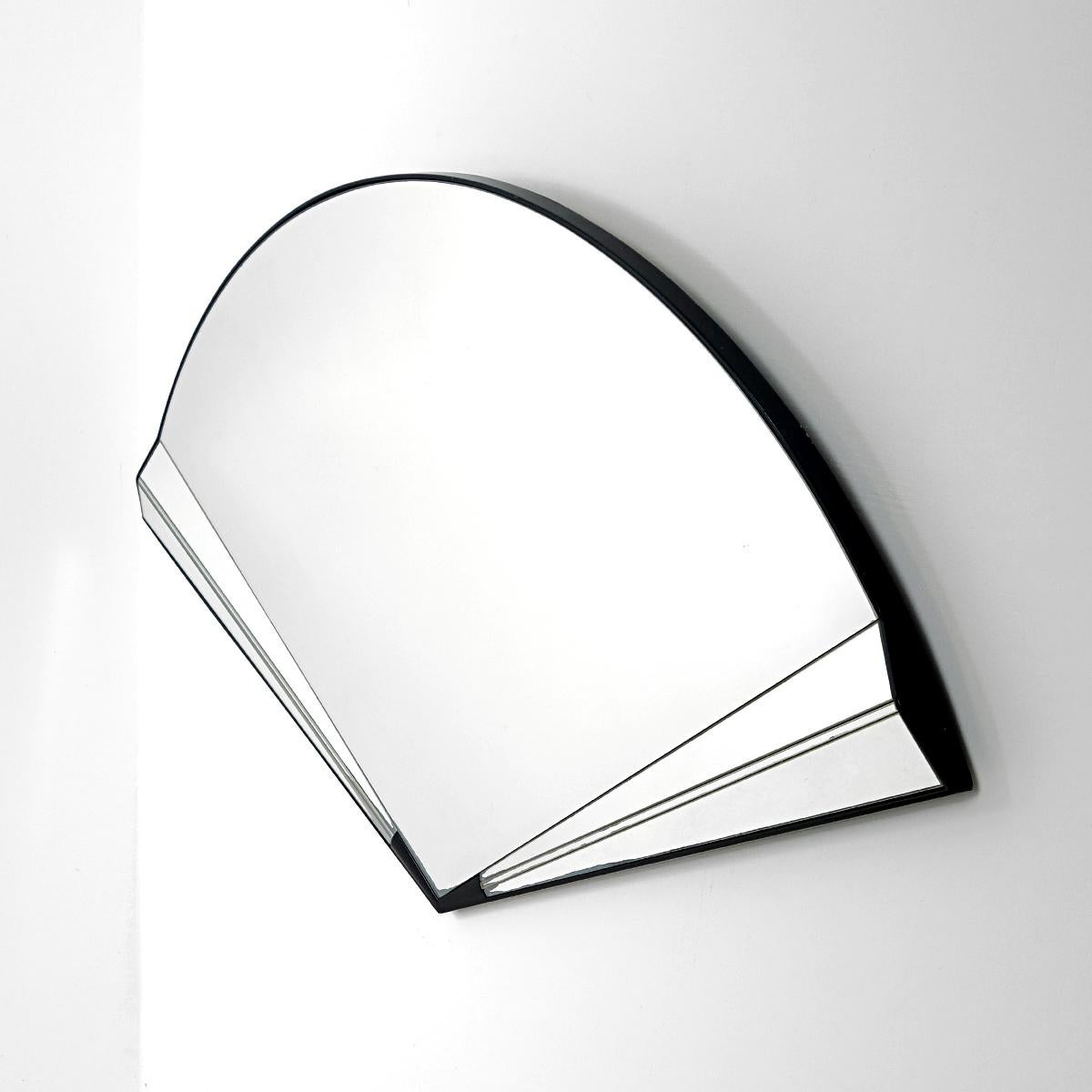 Playful wall mirror in the shape of a handheld fan.
