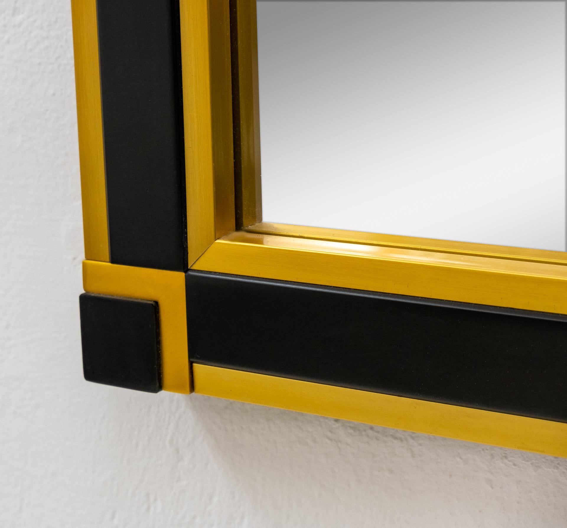 Very nice Postmodern wall mirror. Black wood and gold color brass rim. Good quality mirror.
Made in Italy, 1980s.
       