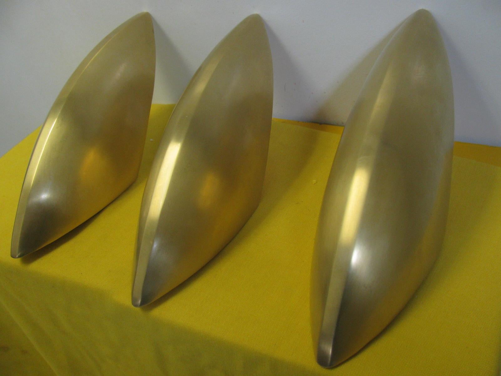 Fabulous set of 3 solid brass, very heavy, sconces. Smooth and streamlined clean lines. High top quality with white enameled interior. Sold individually or by the set of 3. New old stock. Never used. Sold and priced individually.