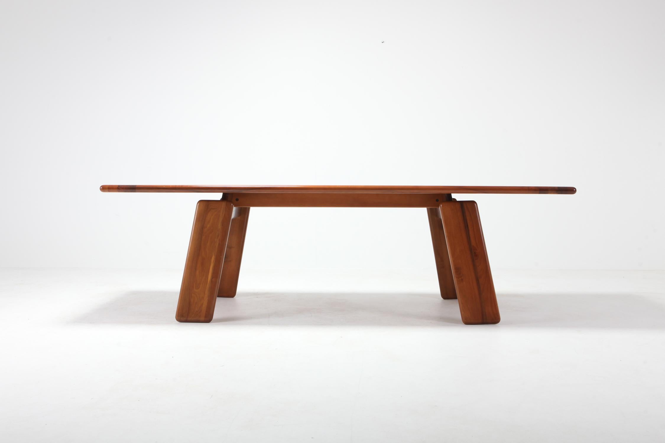 Walnut dining table by Afra & Tobia Scarpa 

This impressive piece fits 8 to 10 
Amazingly beautiful pieces of walnut have been used to construct this postmodern piece.
through it's design the table top kind of floats over the trapezoid