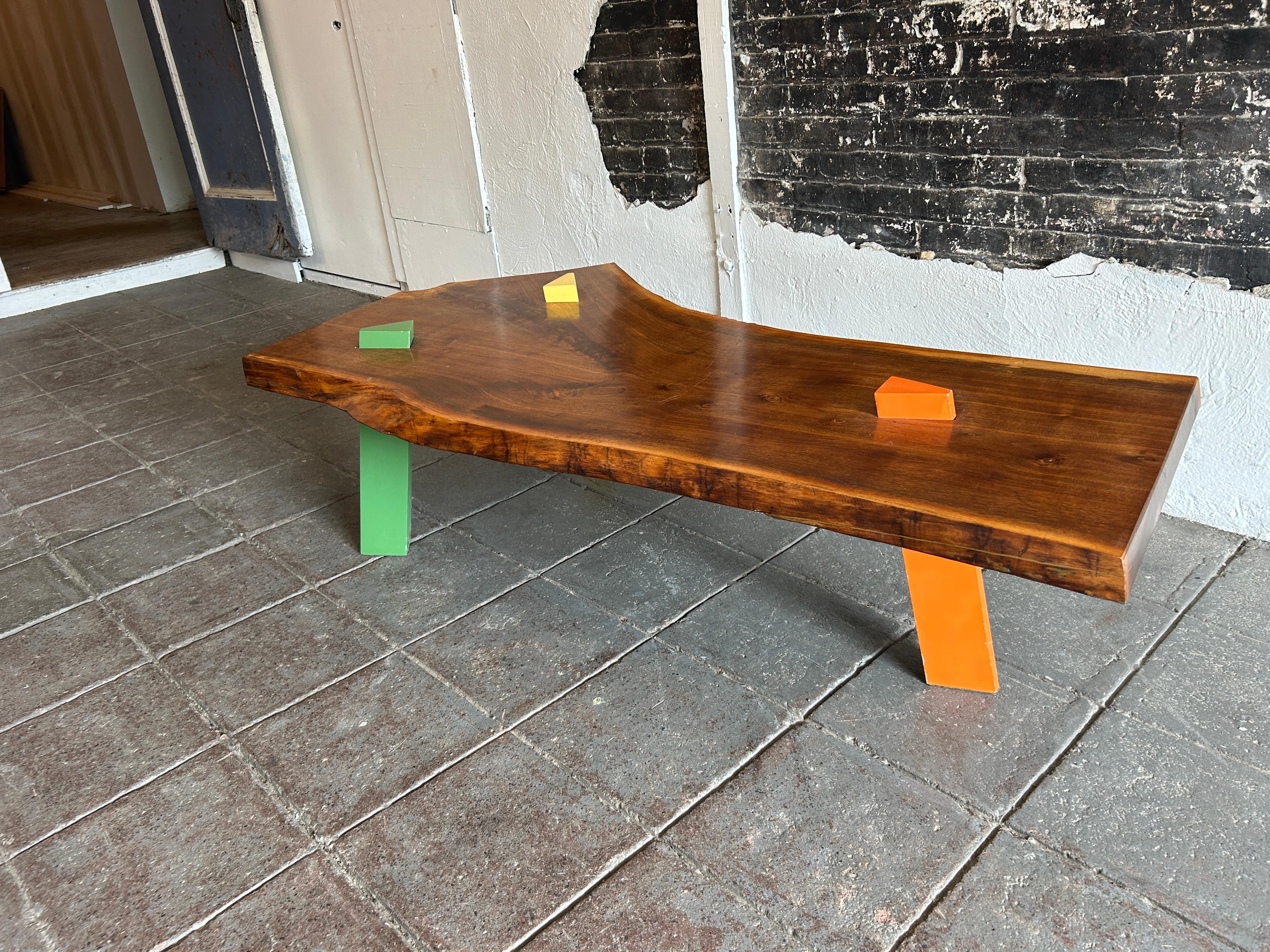 American Post Modern Walnut Slab coffee table with colored triangle legs studio craft For Sale