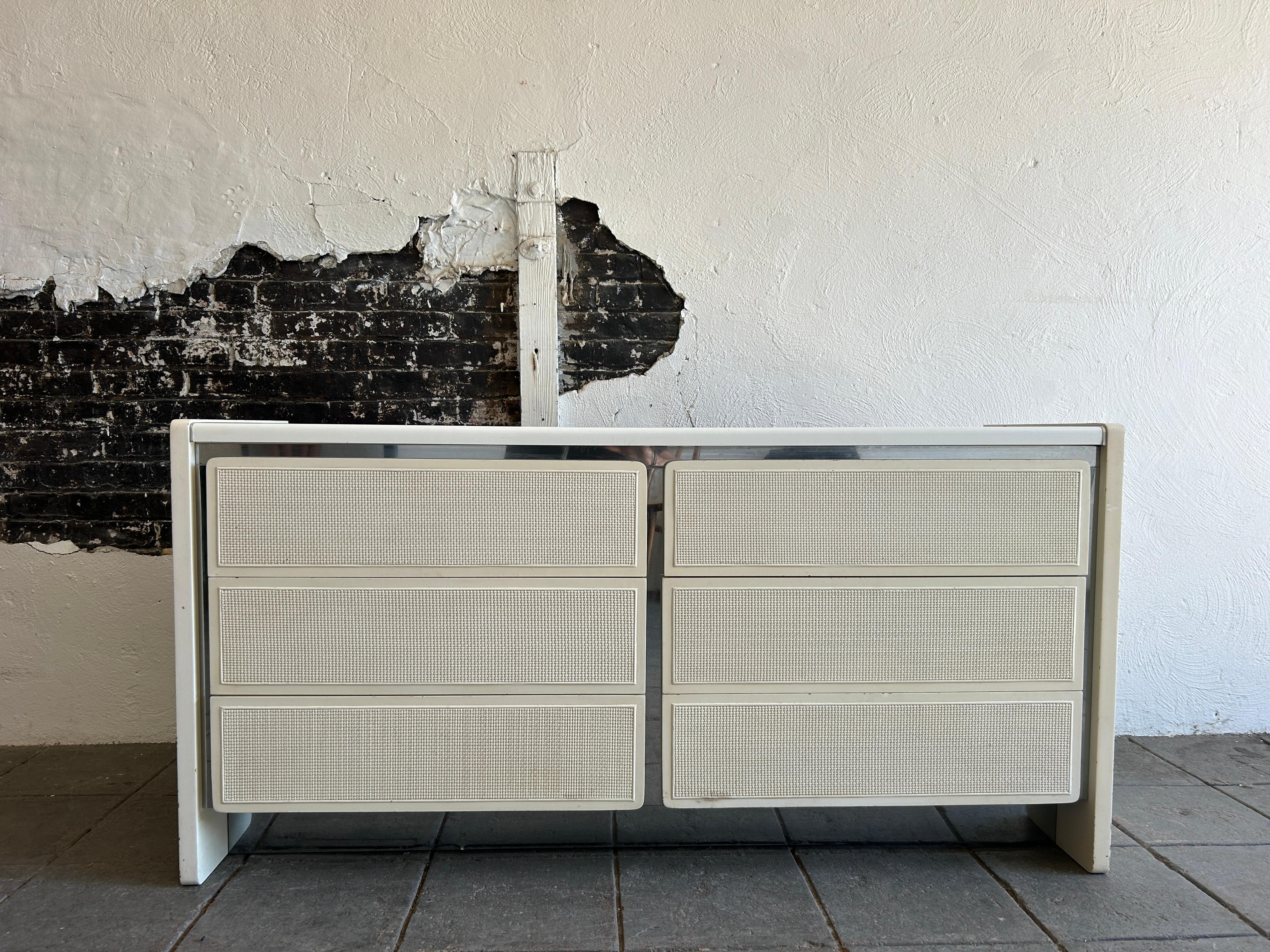 Post modern white cane chrome 6 drawer dresser credenza. White lacquer top with cream lacquer cane drawer fronts and sides. Has chrome accents behind drawers. Drawers are made of solid oak with metal drawer glides. Very solid dresser with post