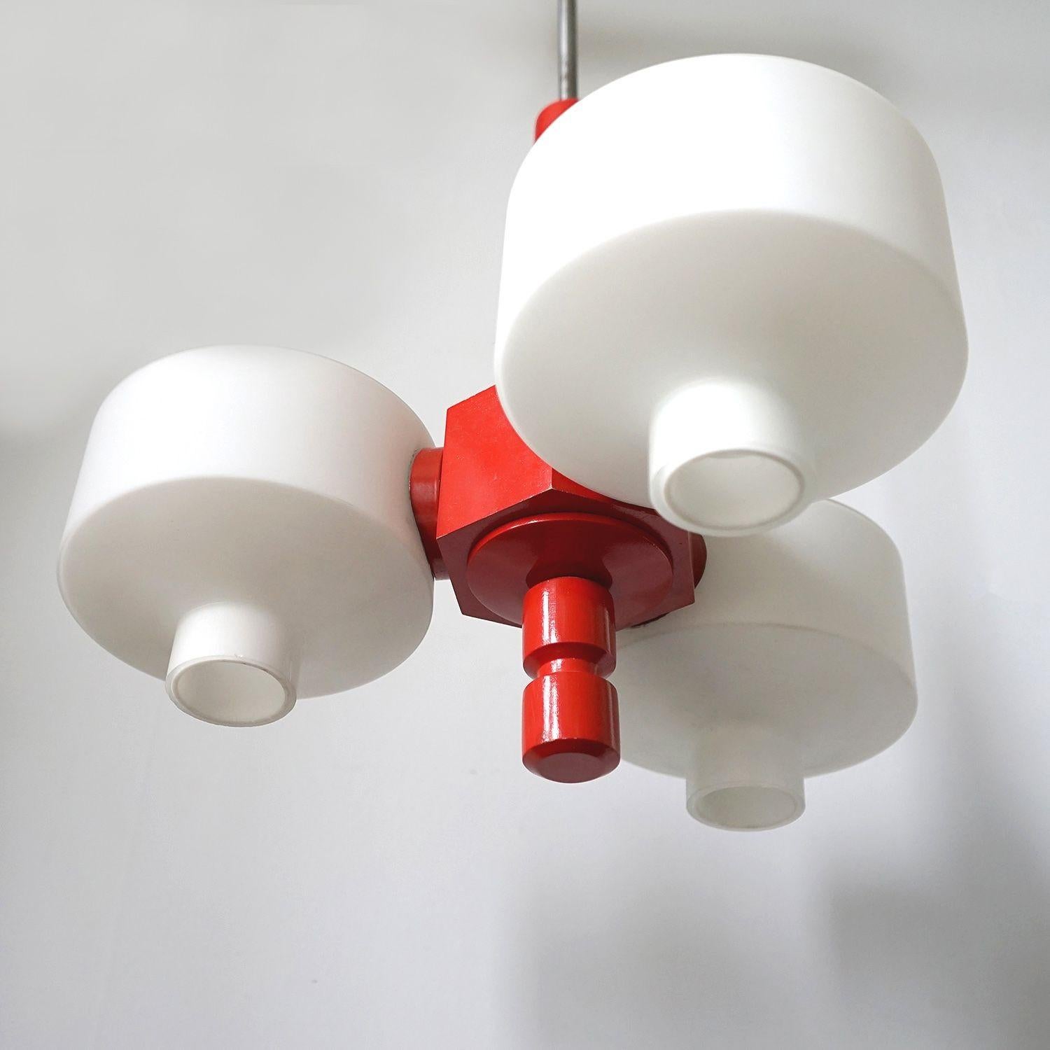 German Vintage mid century three branch ceiling light

Red lacquered turned wooden frame with frosted opaline glass shades.

It is in very good vintage condition with only minor wear commensurate with age.

Rewired and safety tested by our