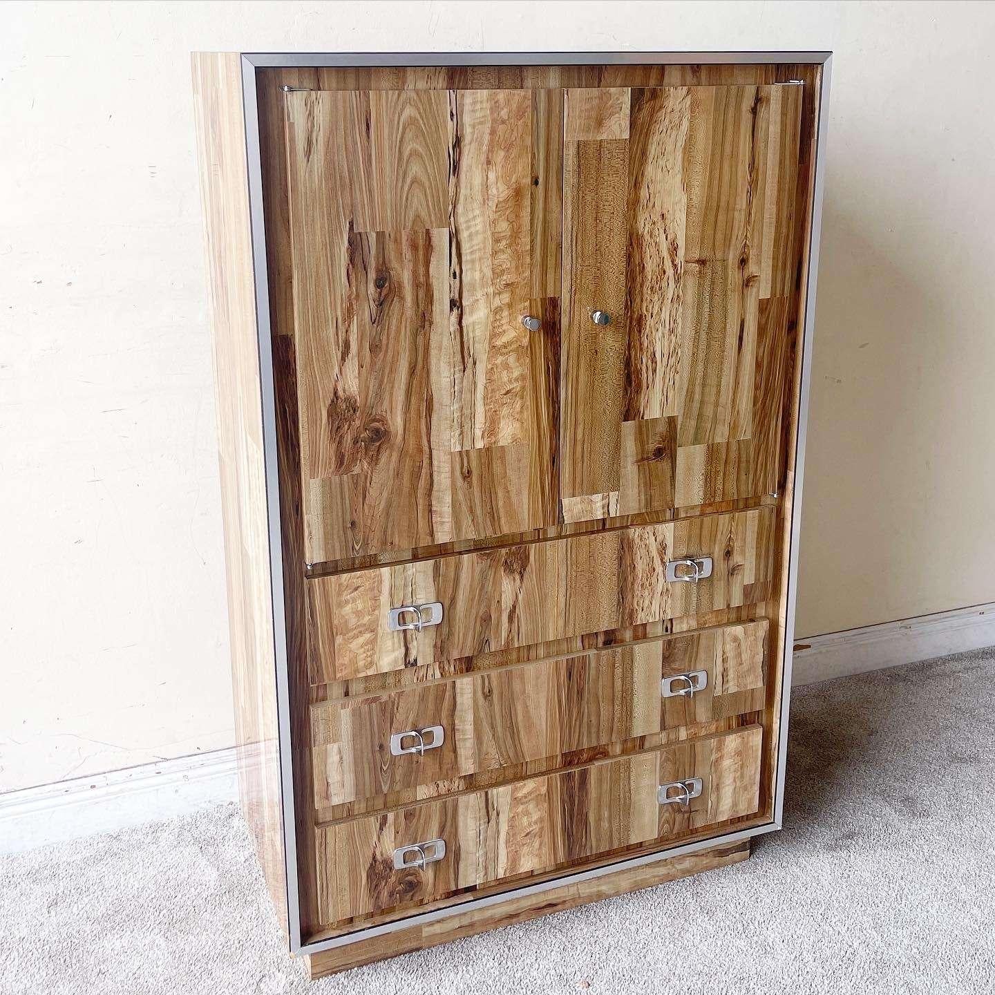 Incredible vintage postmodern armoire with three spacious drawers. Features a Woodgrain glossy laminate with a silver edge and chrome handles.

