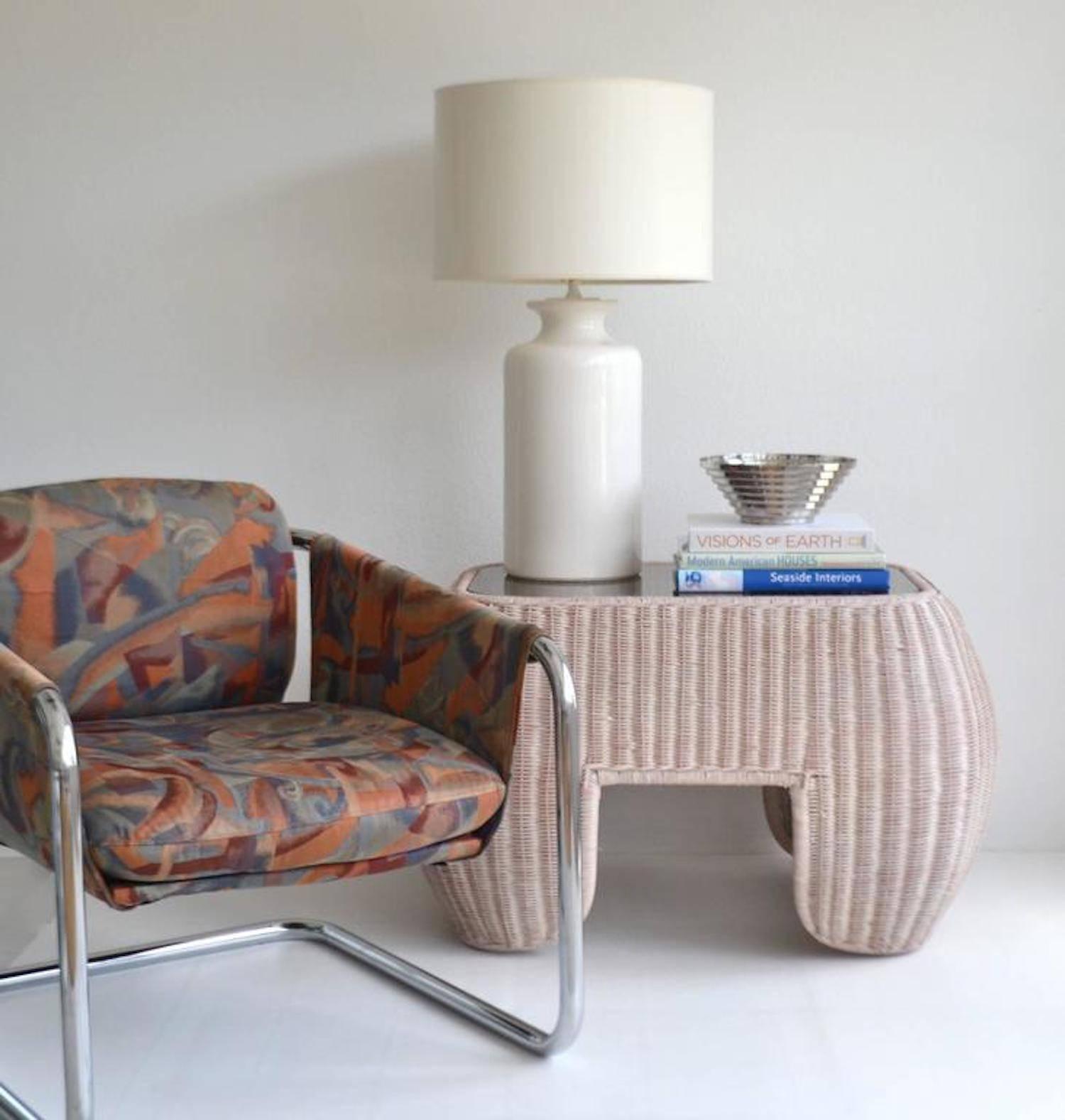 Glamorous Postmodern woven reed side table, circa 1970s-1980s. This striking sculptural cerused rattan end table is finished with an inset glass top. Could be versatility used as a cocktail table or coffee table.