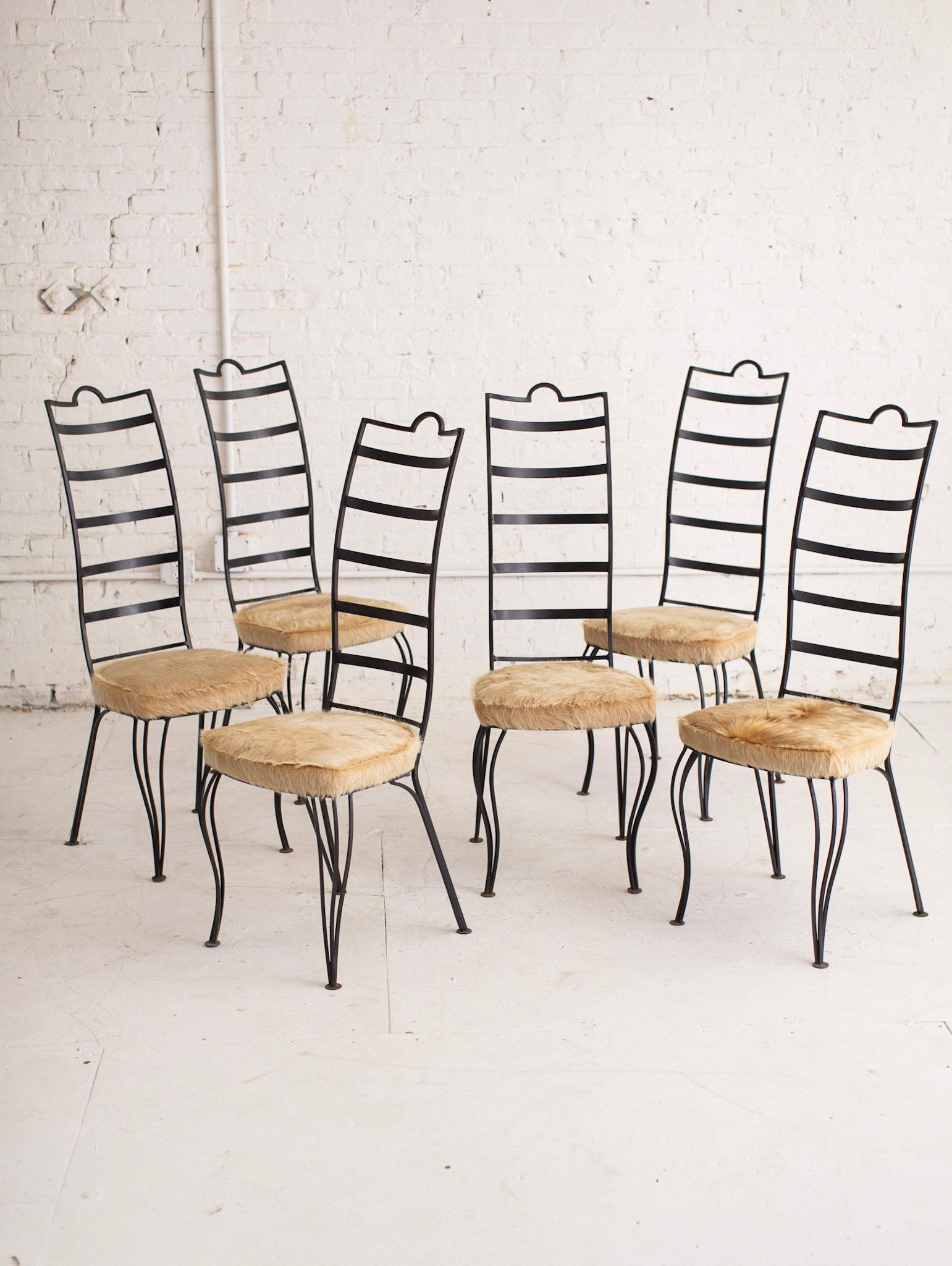 Set of six post modern ladderback dining chairs. Serpentine silhouette. Newly reupholstered in a shaggy cow hide. Due to the nature of hide natural blemishes and variations are to be expected.