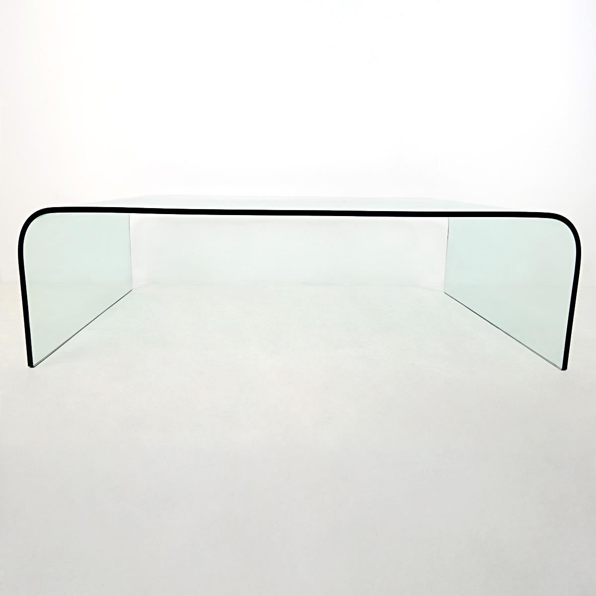The glass coffee table waterfall was designed by Angelo Cortesi for Fiam Italia. This is the extra wide version. This elegant yet solid and spacious table is made of thick curved glass.