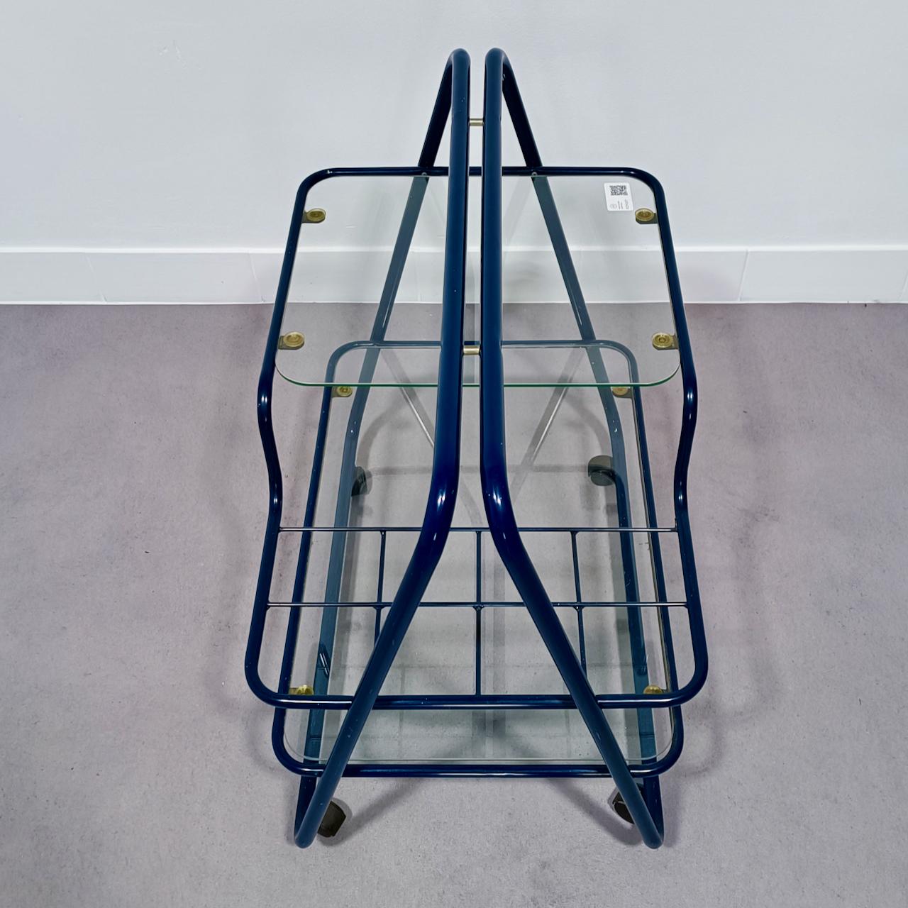 Pop Modern bar cart.
The blue colour is key for the Pop Art culture.
In the early 1990's there was a revival of the Mid Century Pop Art;
called Post Pop.
The wheels on the bar cat tell us that it is not Mid Century but 1990's.
Bar cart has a tubular
