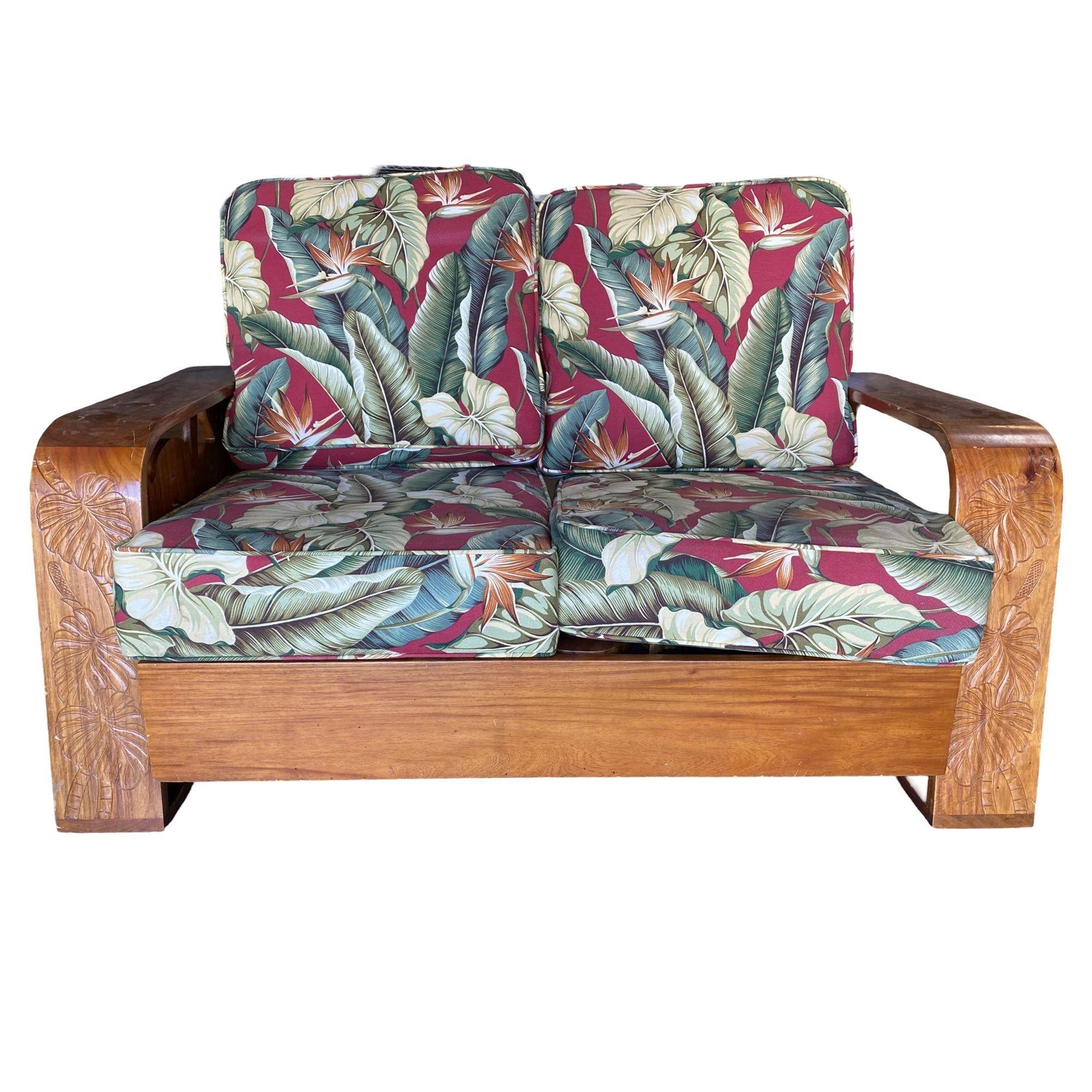 Late 1940's carved koa wood tropical loveseat featuring large wood panels carved into palm leaves fixed to streamline speed arms. This is a great transitional piece featuring mid-century styling with distinct Art Deco Influence and an early example