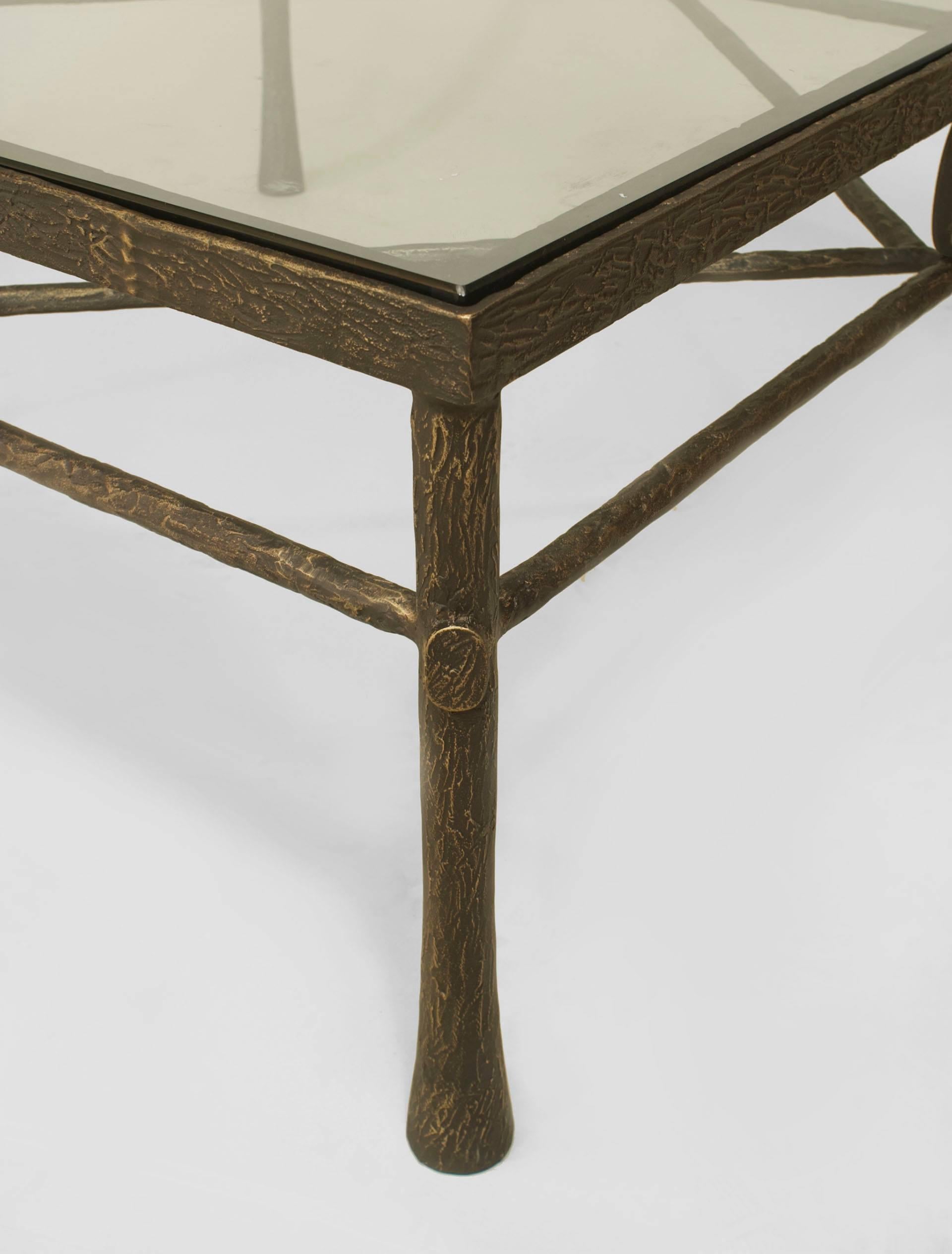 Postwar design (Giacometti style) textured dark bronze patina square coffee table with stretcher having a centred medallion and inset glass top (Carol Gratale Design).

  