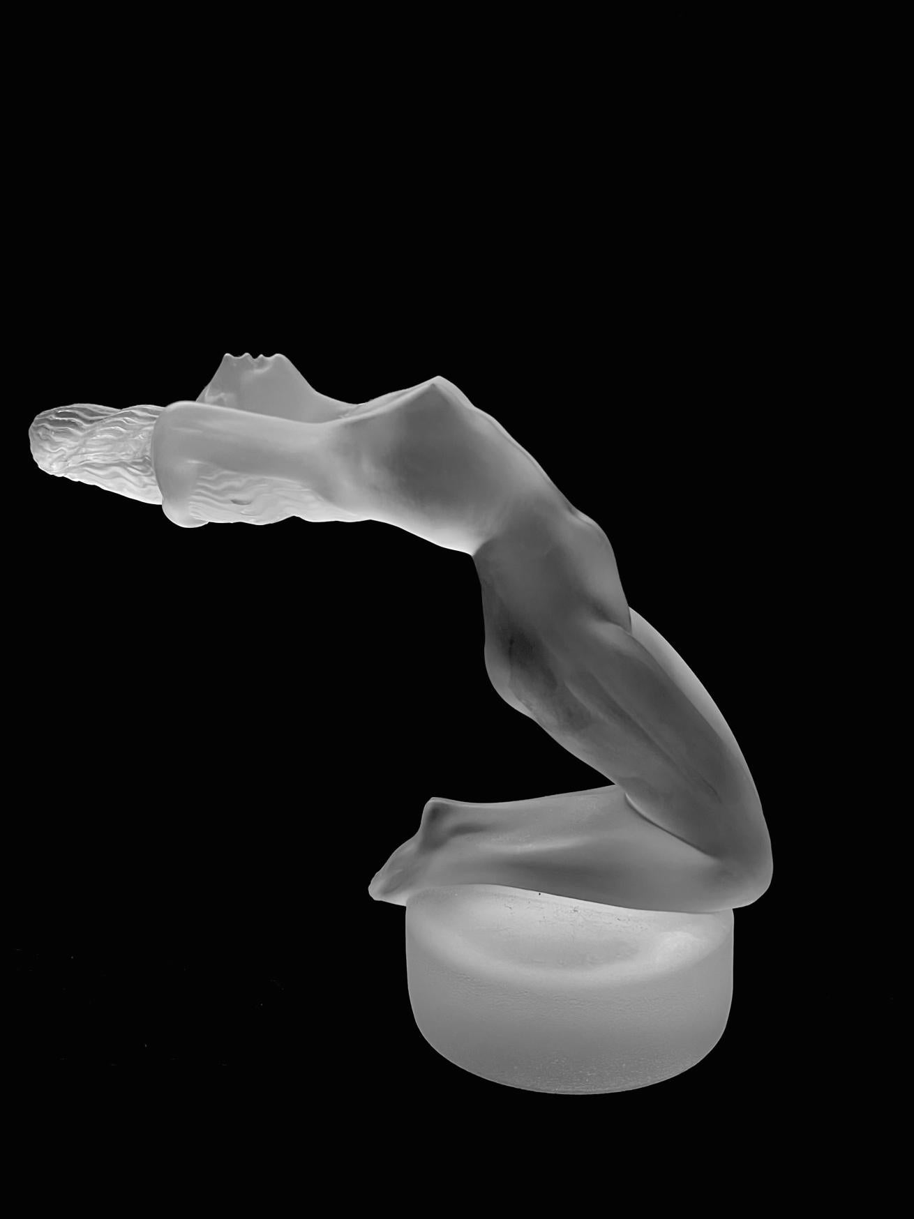 A post war Lalique 'Chrysis'  crystal statuette modeled as a kneeling nude with arched back and her hair flowing in the wind. Signed  