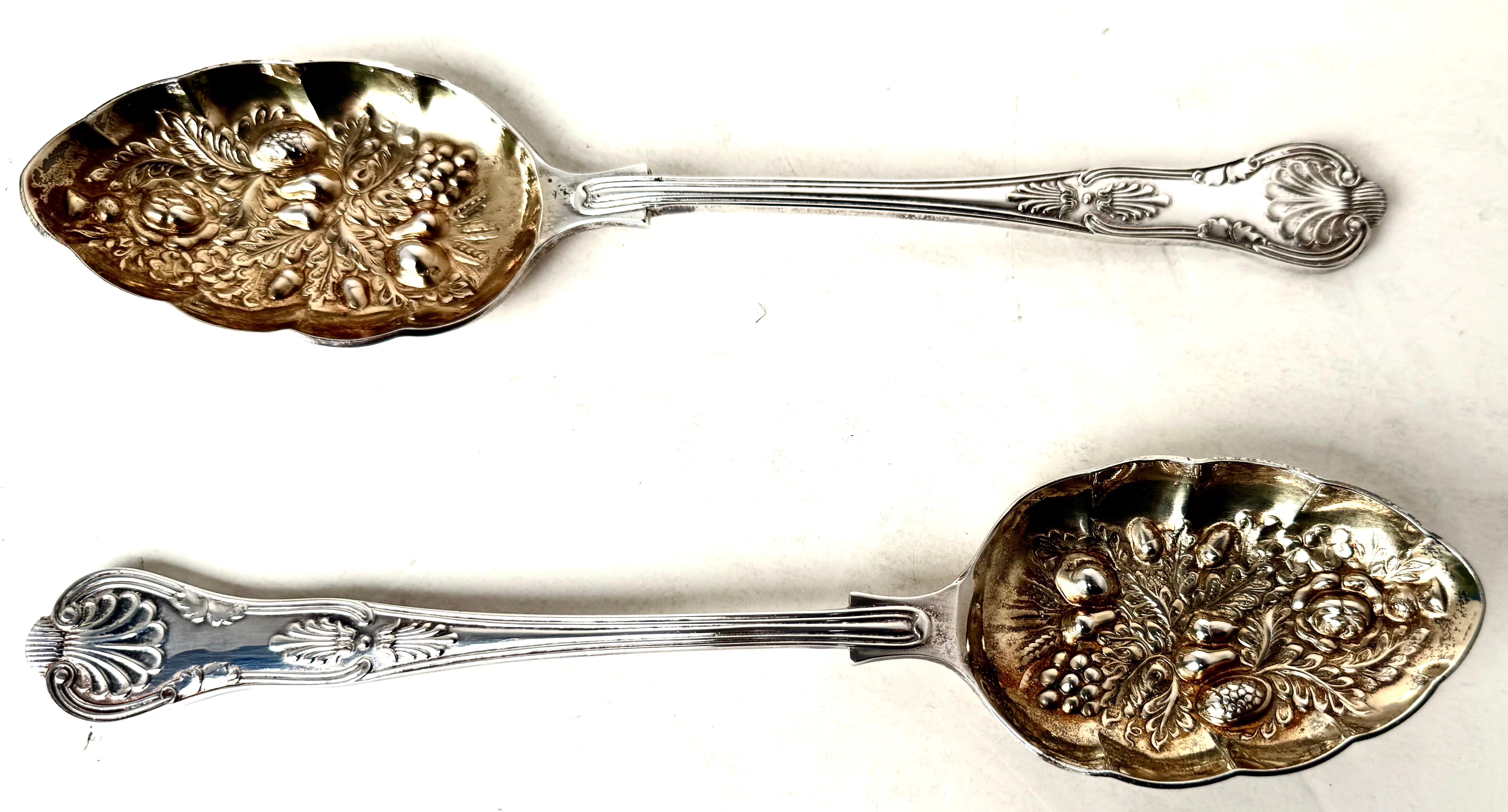 Beautiful pair of Sheffield silver plated salad spoons (marked) with gold fill bowl (see images) mounted in the original silk lined interior case. Bowl of the spoon  is decorated in fruit, nut, and floral raised relief repousse pattern and gold