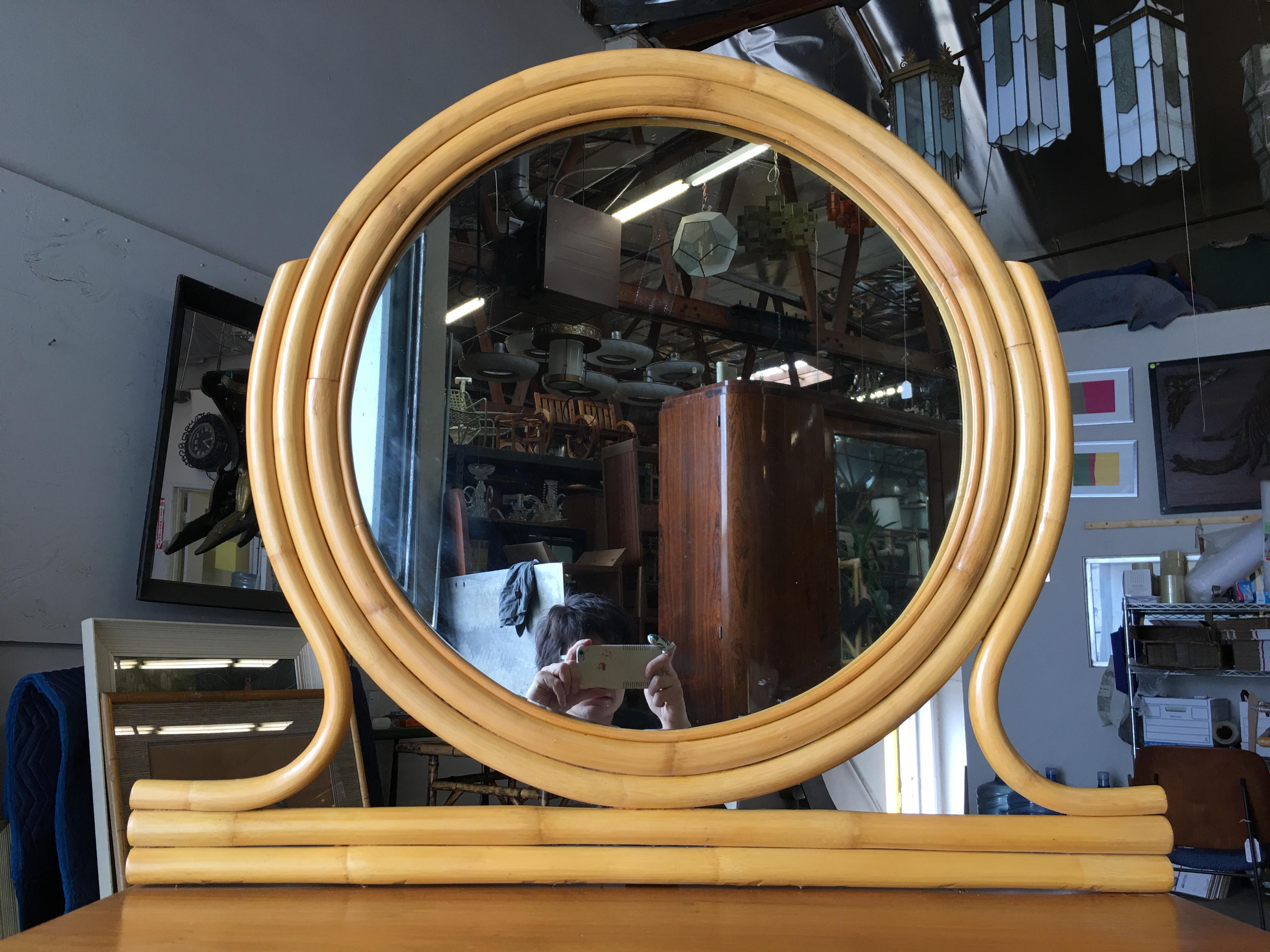 Vintage 1940s Streamline rattan vanity with mahogany top and drawers completed with a top round mirror.