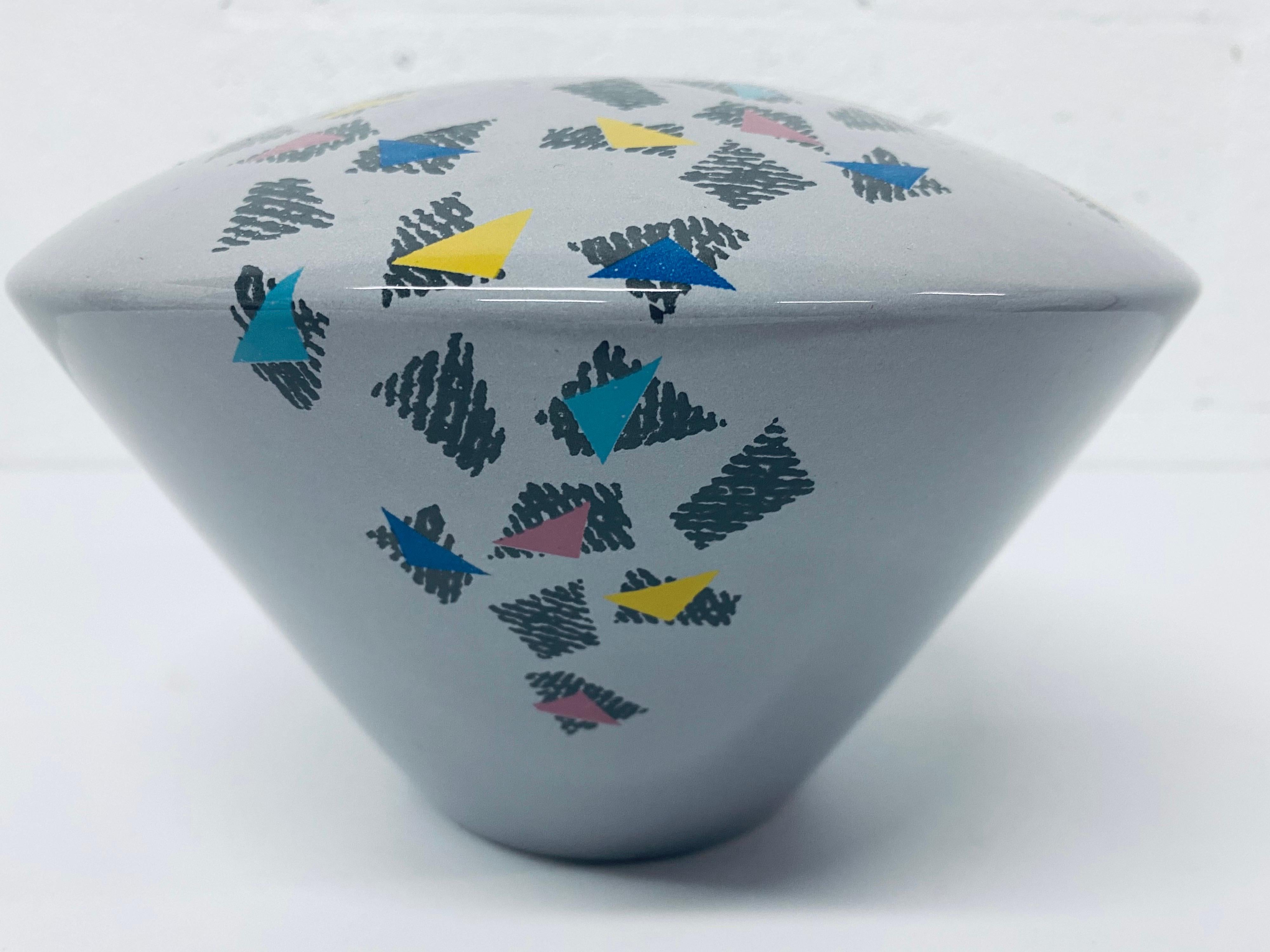 Designed and manufactured by the Baldelli Family of Italy, this saucer like vase has a Postmodern design over a blue gray finish, circa 1980s.