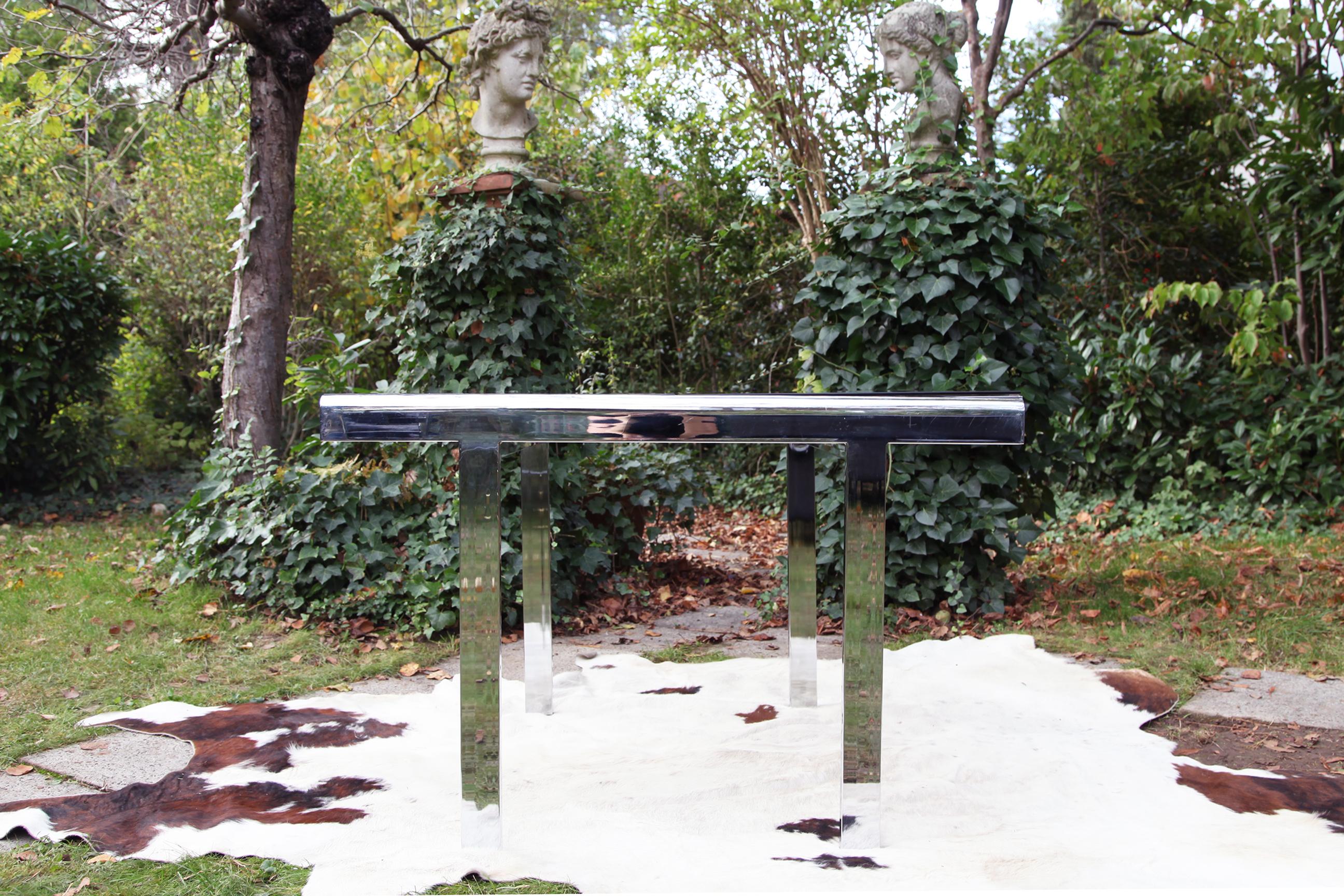 Incredible postmodern extendable smoked glass and chrome dining table, also perfect for use as a desk table.  Excellent size for any space, can form into a square when the leaves are not in use, and extend to a good sized table fitting for 4