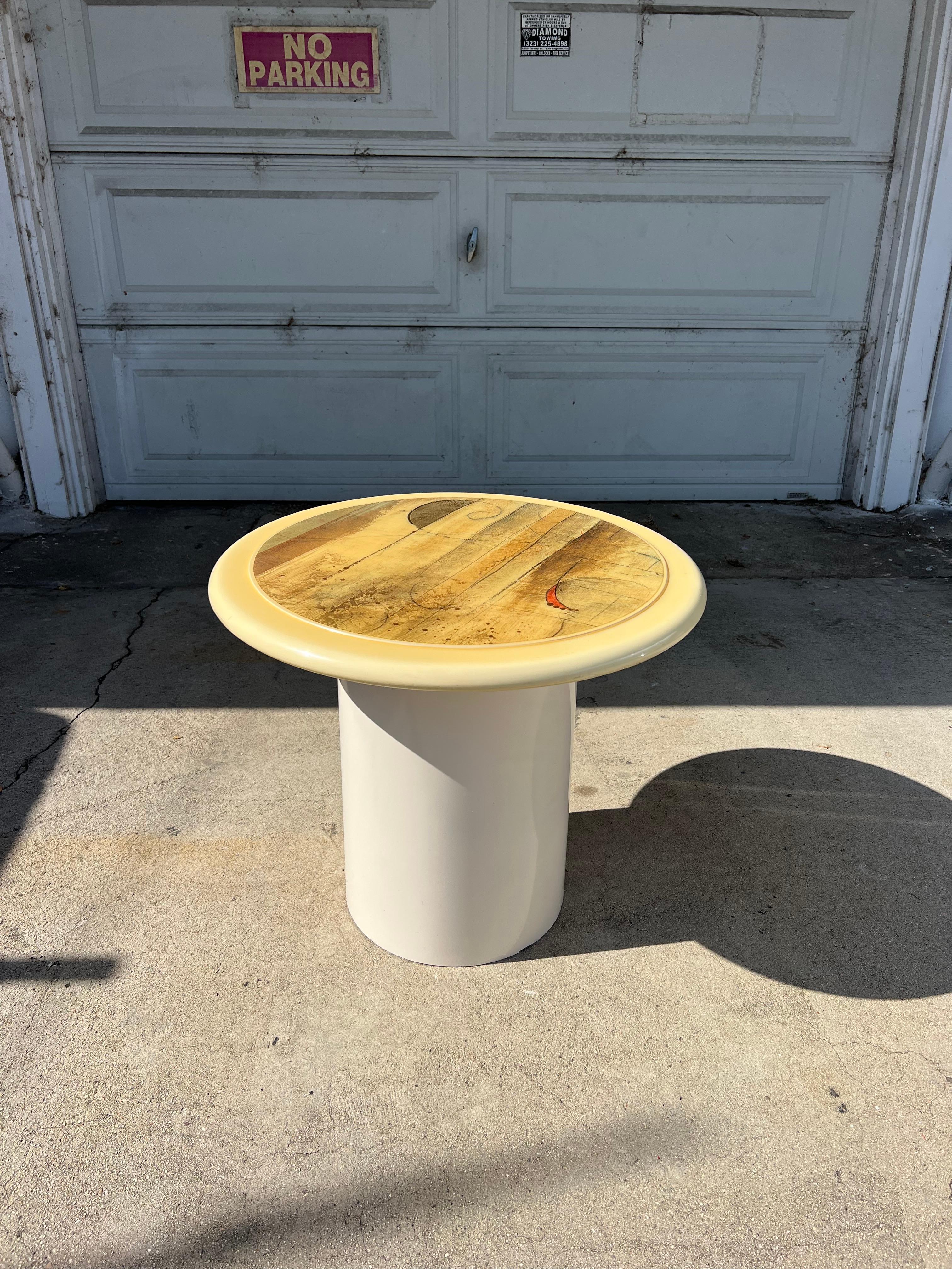 Mushroom shaped side table with epoxied top and white laminate cylindrical body. A whimsical, abstract art top offers a unique blend of postmodern design and fine art.  Perfect for a living room side table, bedroom nightstand, or artists display.