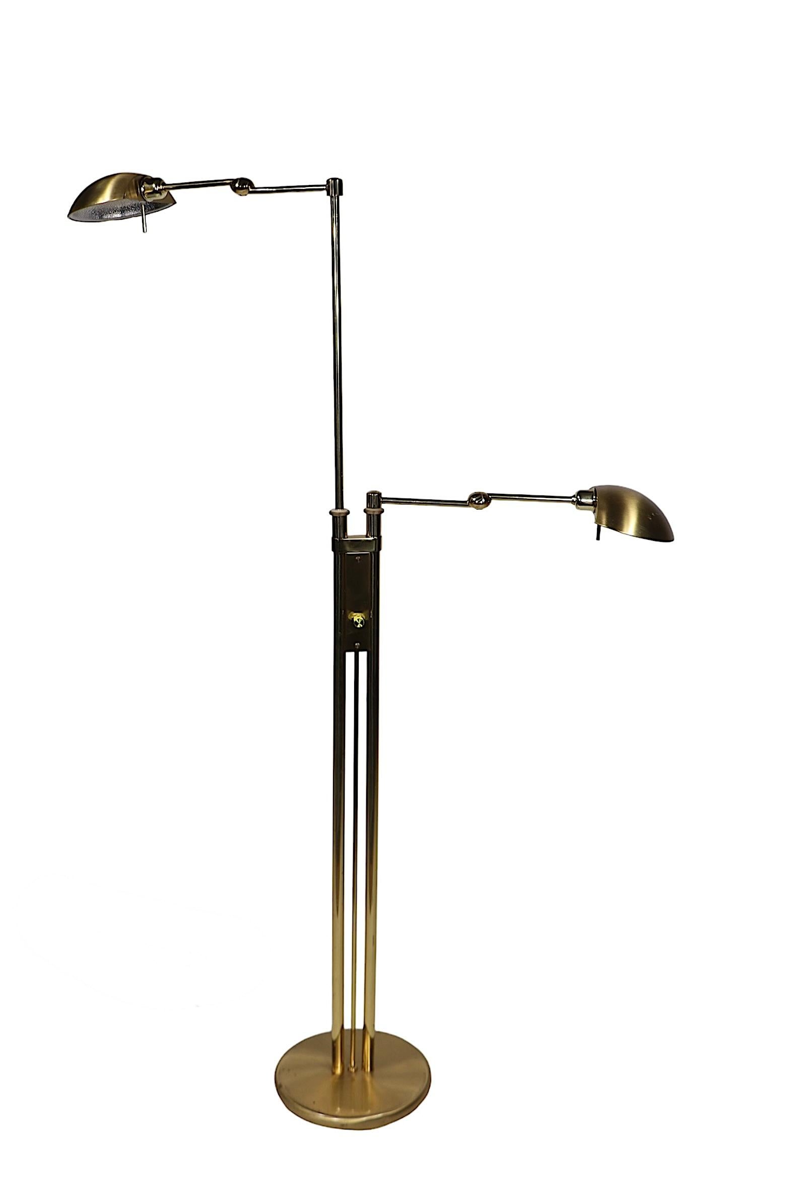 Elegant, sophisticated and chic floor lamp by noted German makers Holtkoetter and Leuchten, circa 1970/80's. The lamp features two lights, each adjustable in height, each having a two section flex arm with a  pivoting hood shade. This example is in