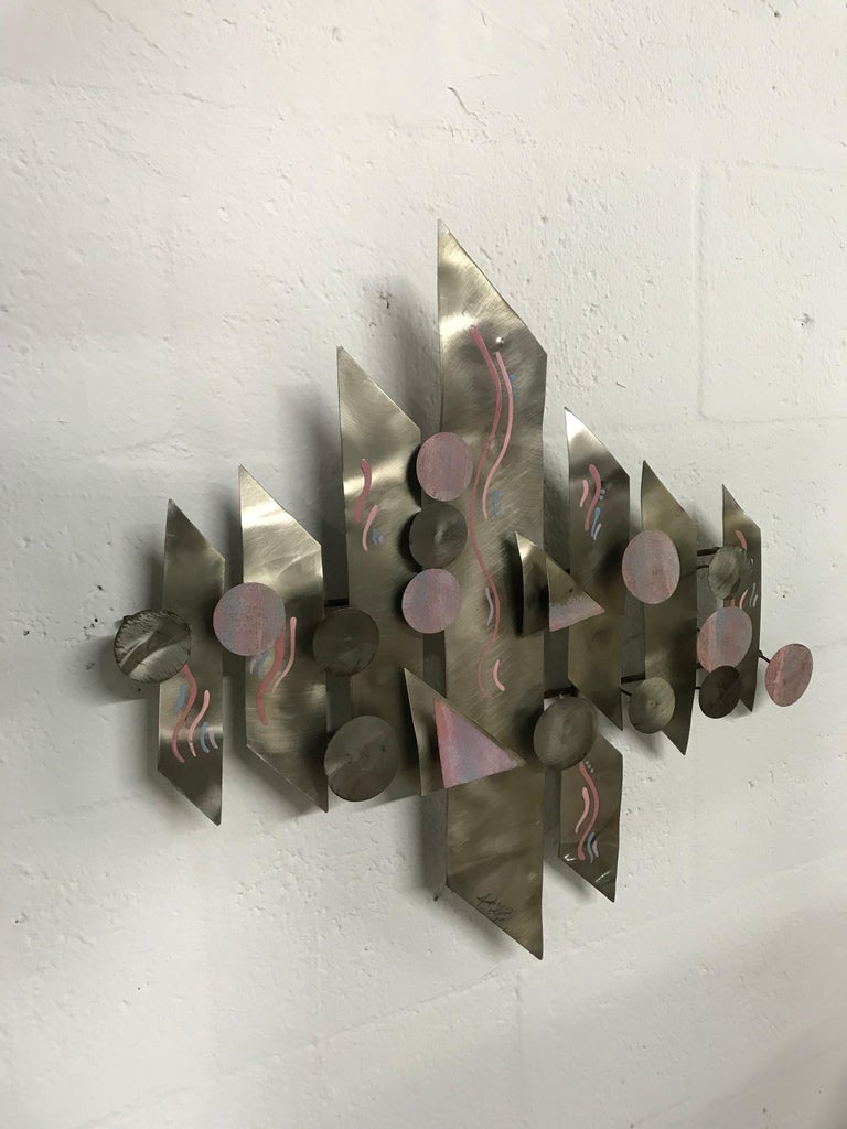 Aluminium and hand-painted wall sculpture signed by artist.