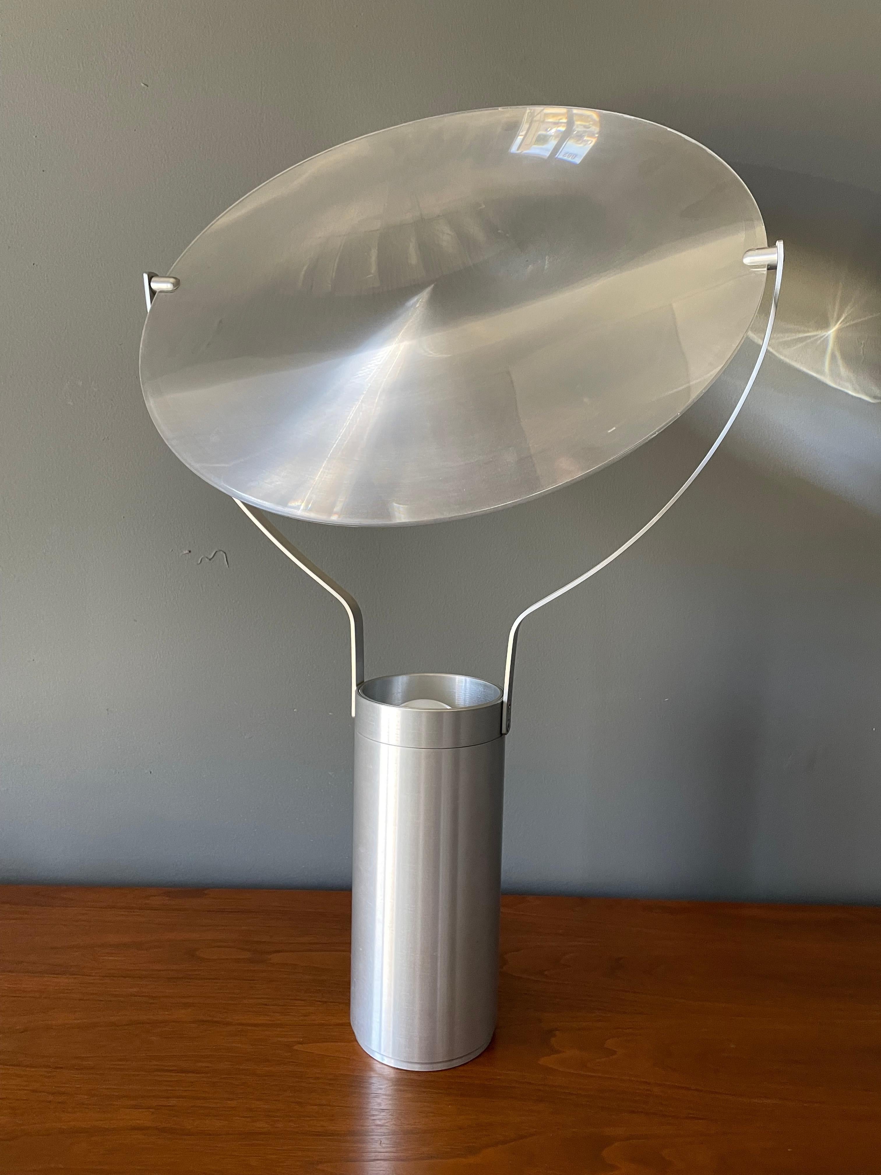 Postmodern spun aluminum and acrylic lamp. Diffuser is positionable in a multitude of different ways. It is equipped with a dimmer switch as well.