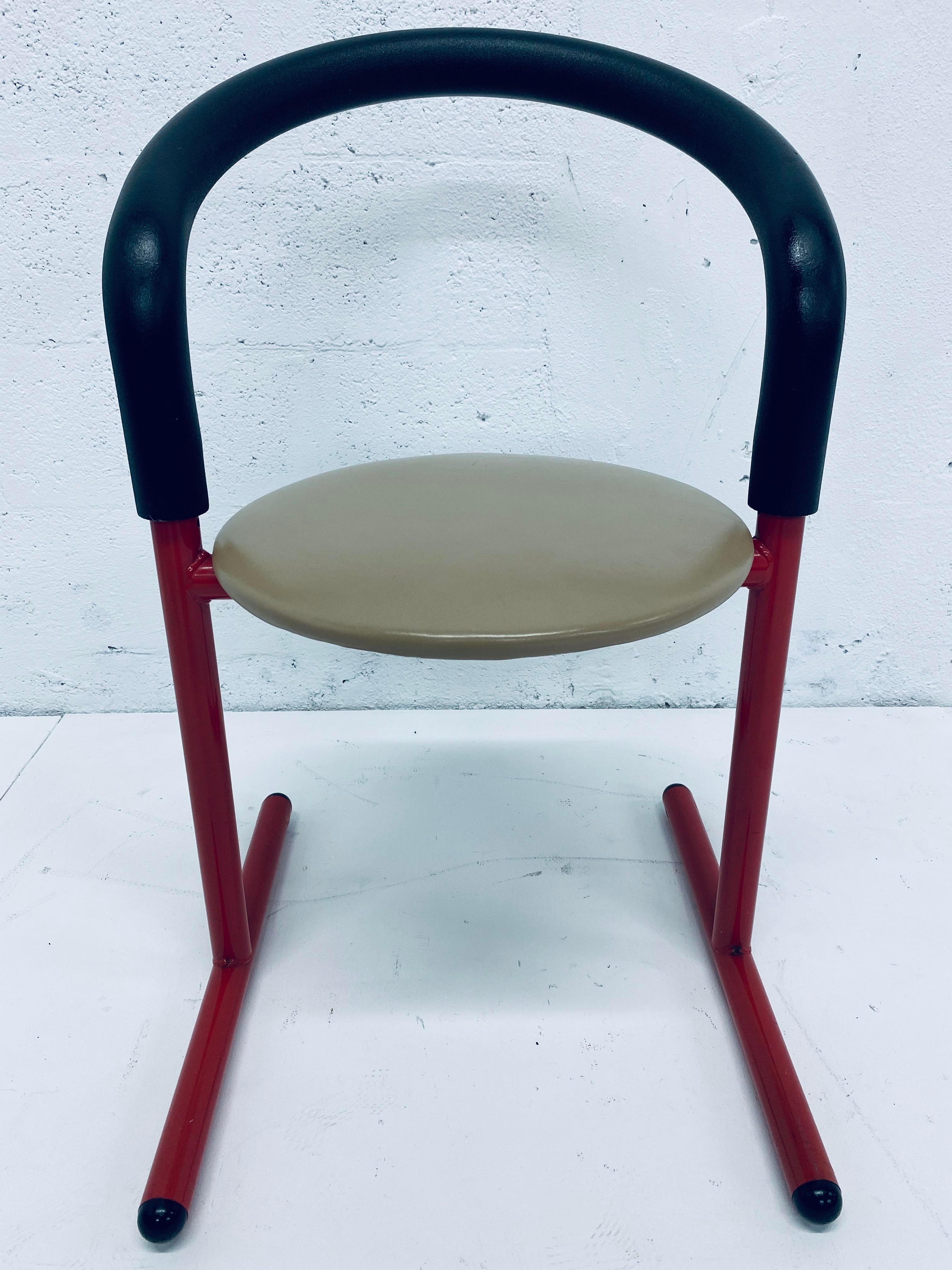 Tubular steel frame in red lacquer with black foam back support and beige seat cushion by Amisco, Canada.