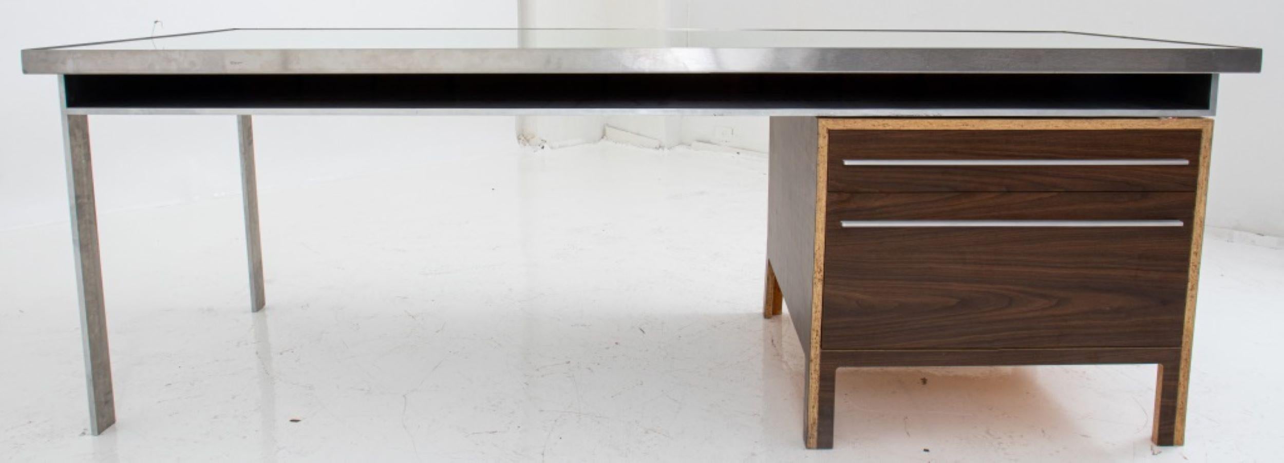 Postmodern architect-designed plywood & steel custom-made desk, the mirrored steelframed top and supporting legs cut from flat panel steel, with recessed chipboard inset, the right return supported by a cut veneered plywood side cabinet with three